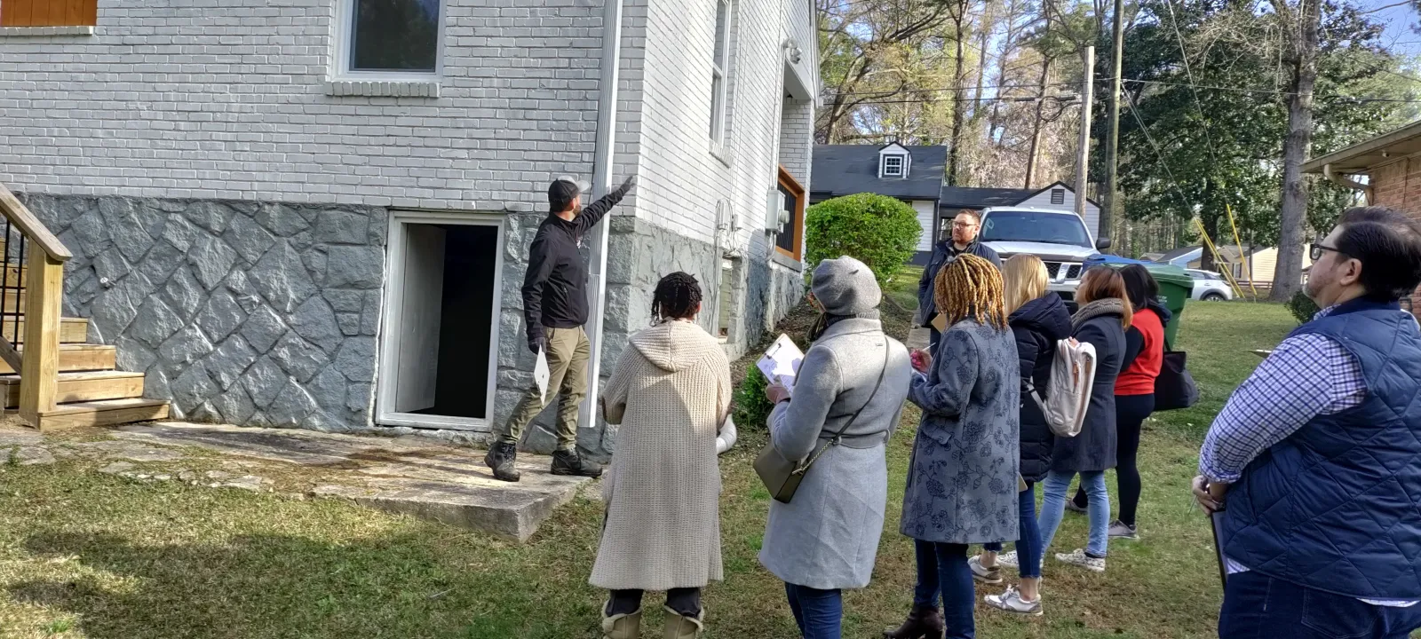 a group of people standing outside a house