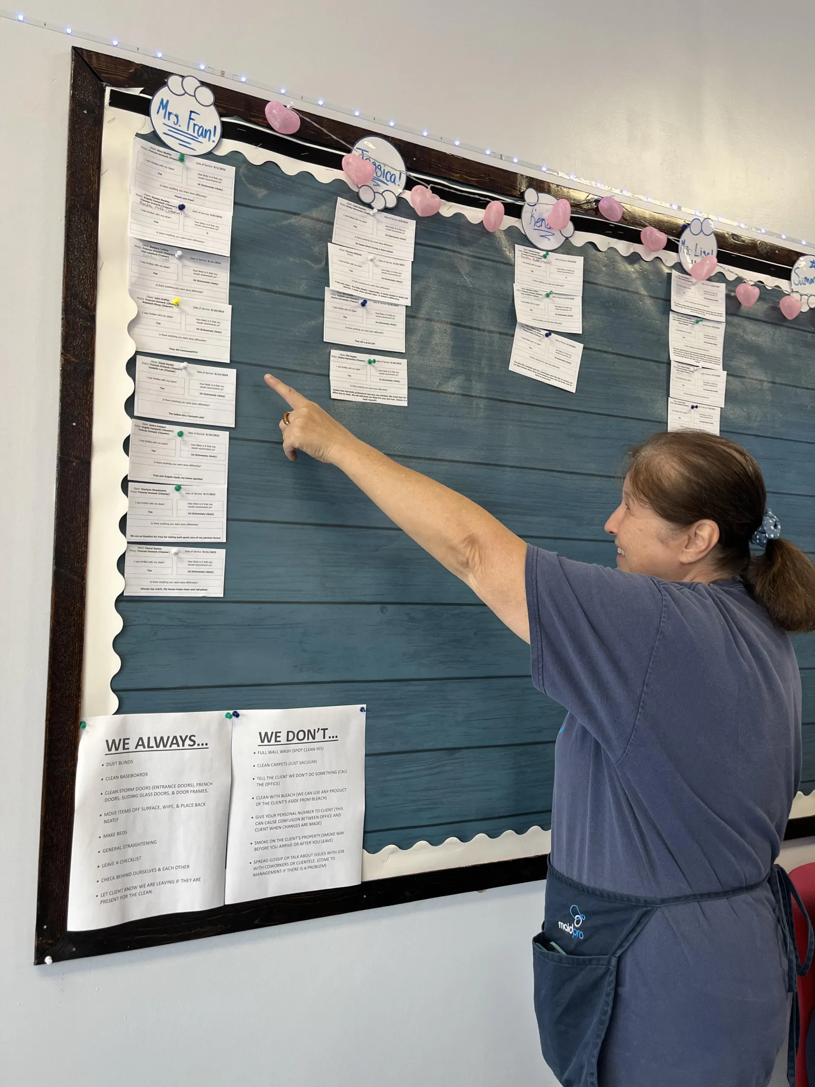 MaidPro Salisbury employee pointing to their cleaning schedule