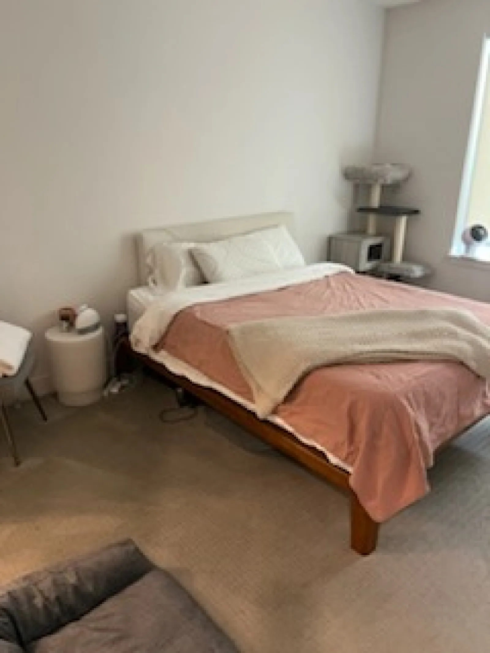 a bed with a brown comforter
