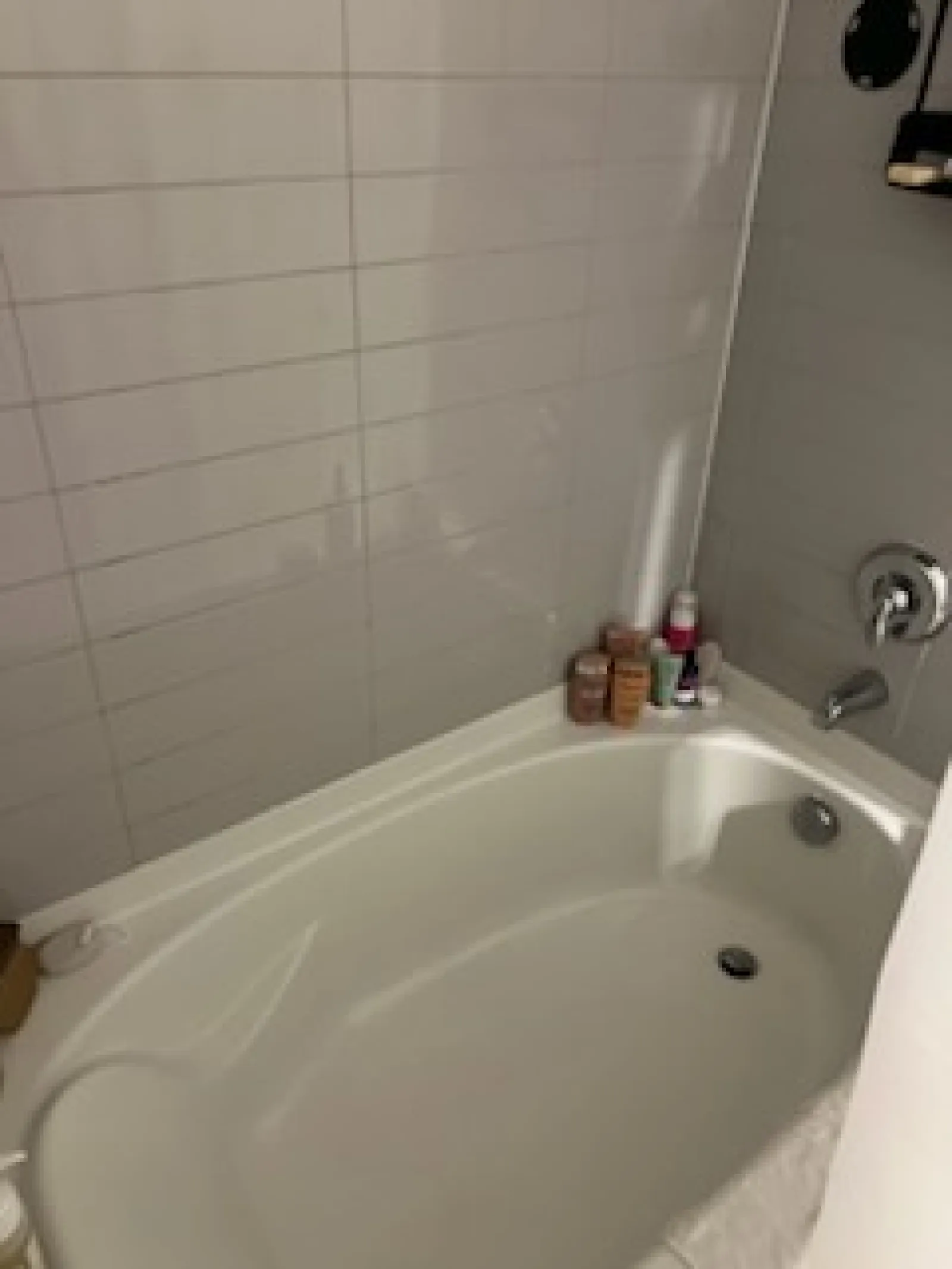 a bathtub with a sink and a shower unit