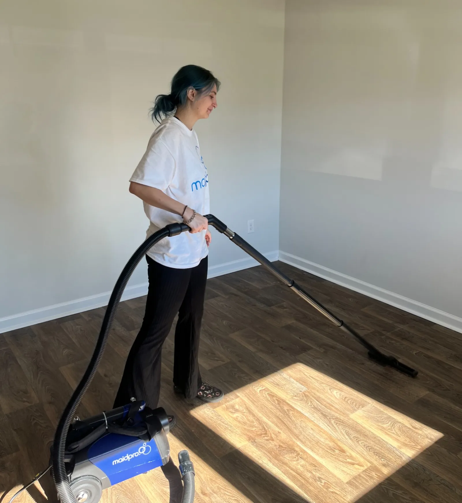 MaidPro Charleston house cleaner vaccuming a hardwood floor in North Carolina