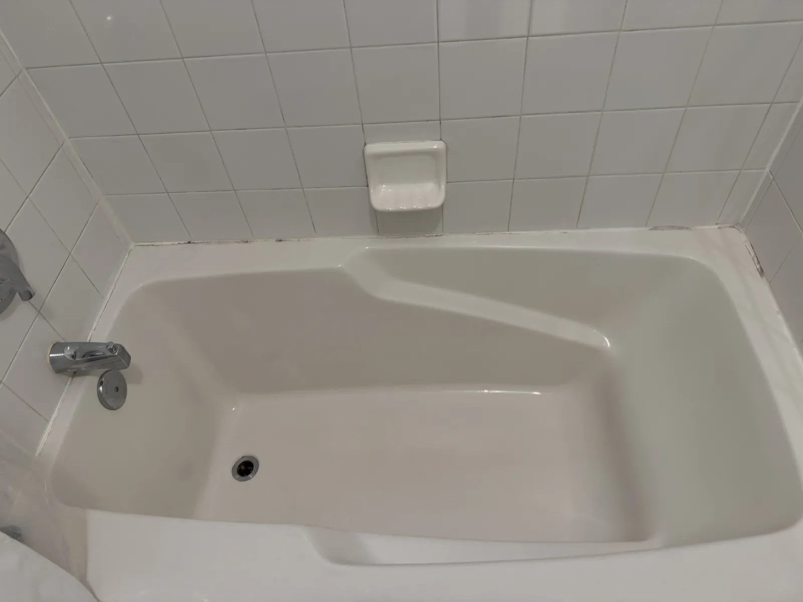a bathtub with a tissue box