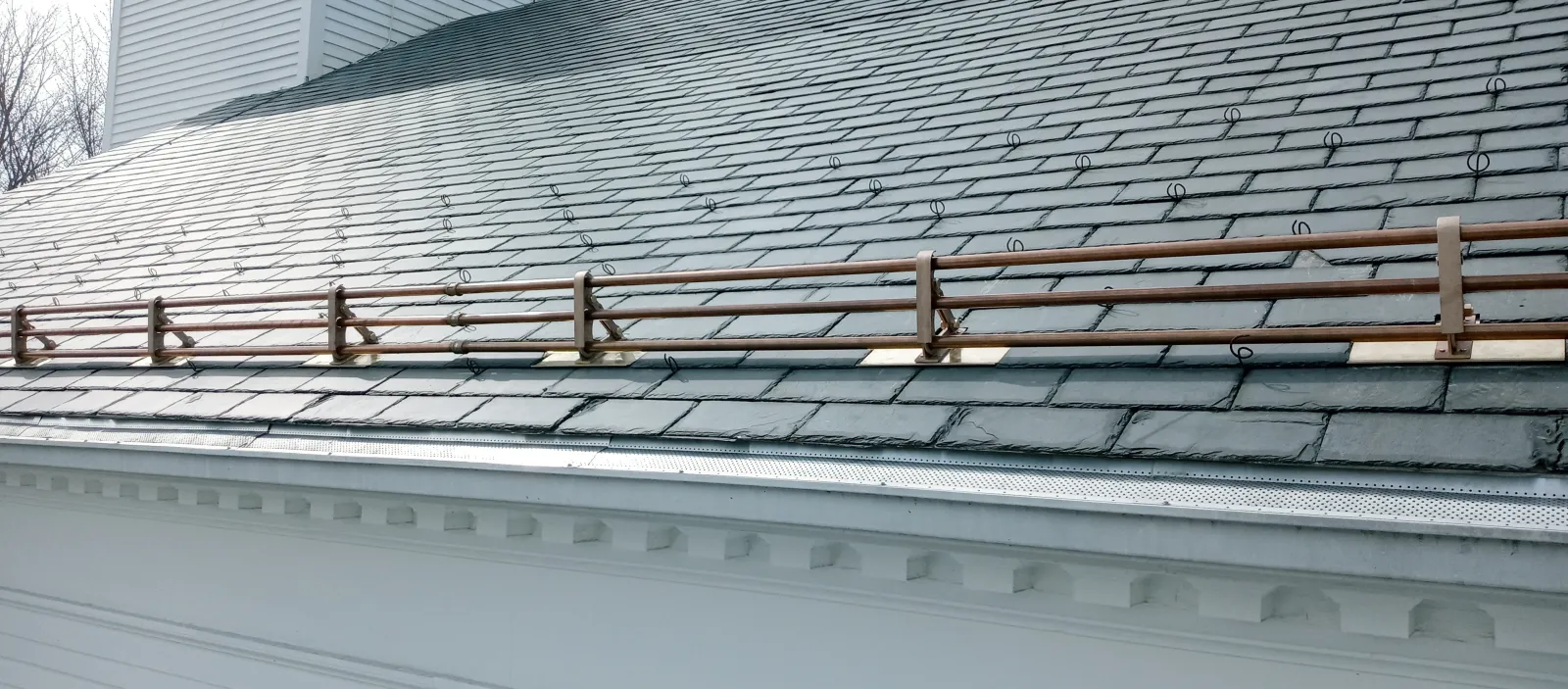a roof with a wood railing