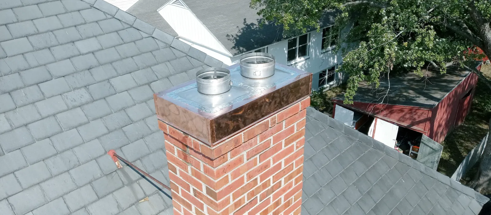a roof with a chimney and a pot on it