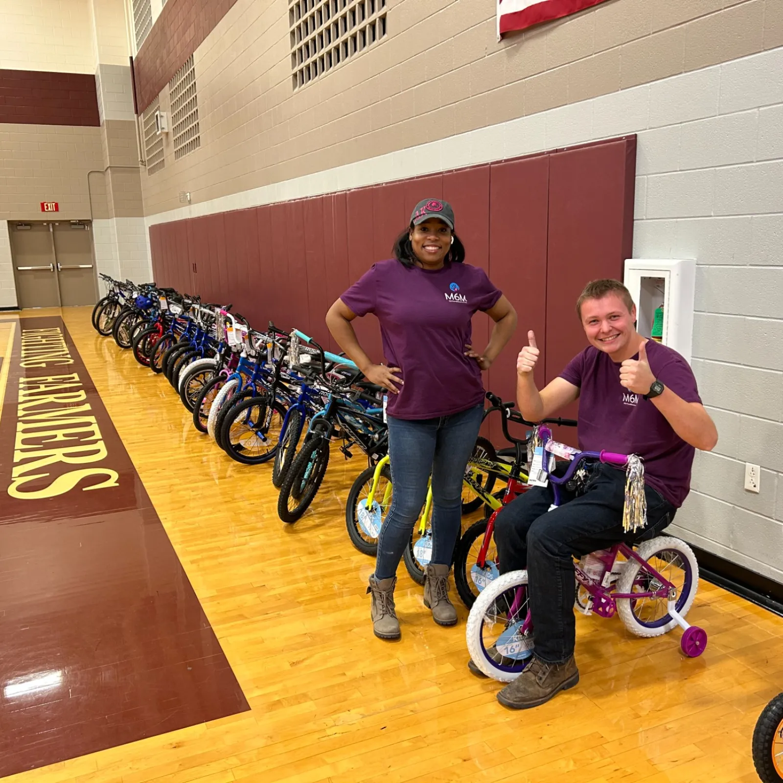 a man and a woman on wheelchairs in a gym