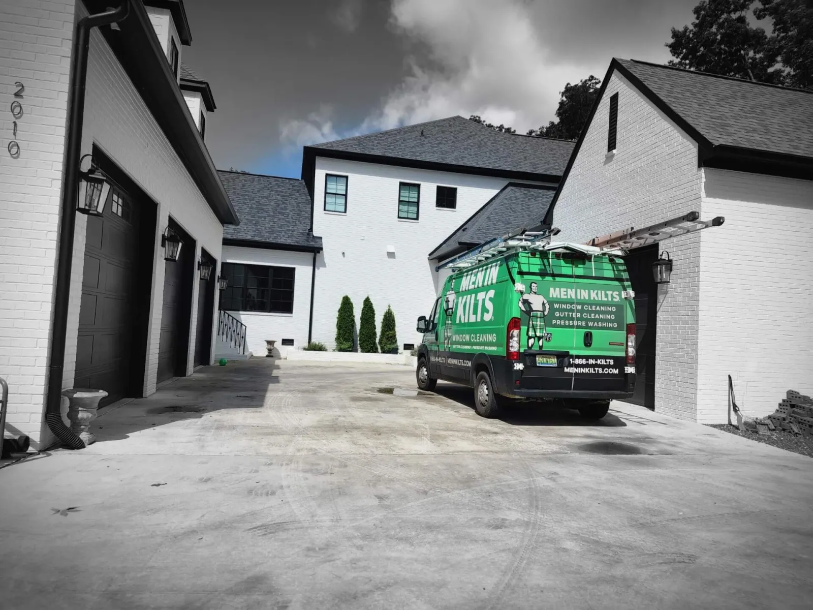 a green van parked in a driveway