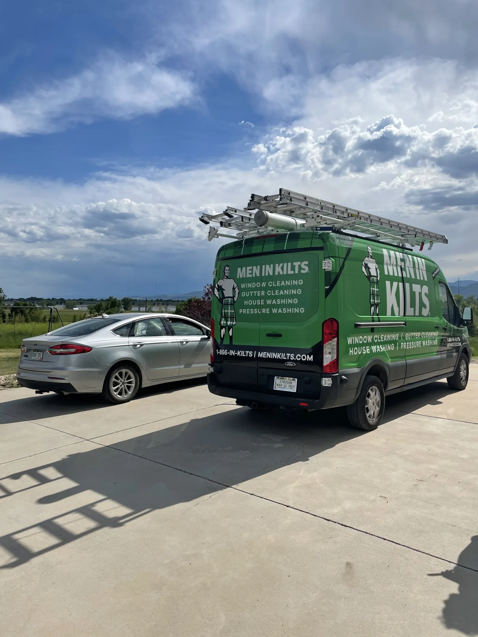 a green truck and a silver car