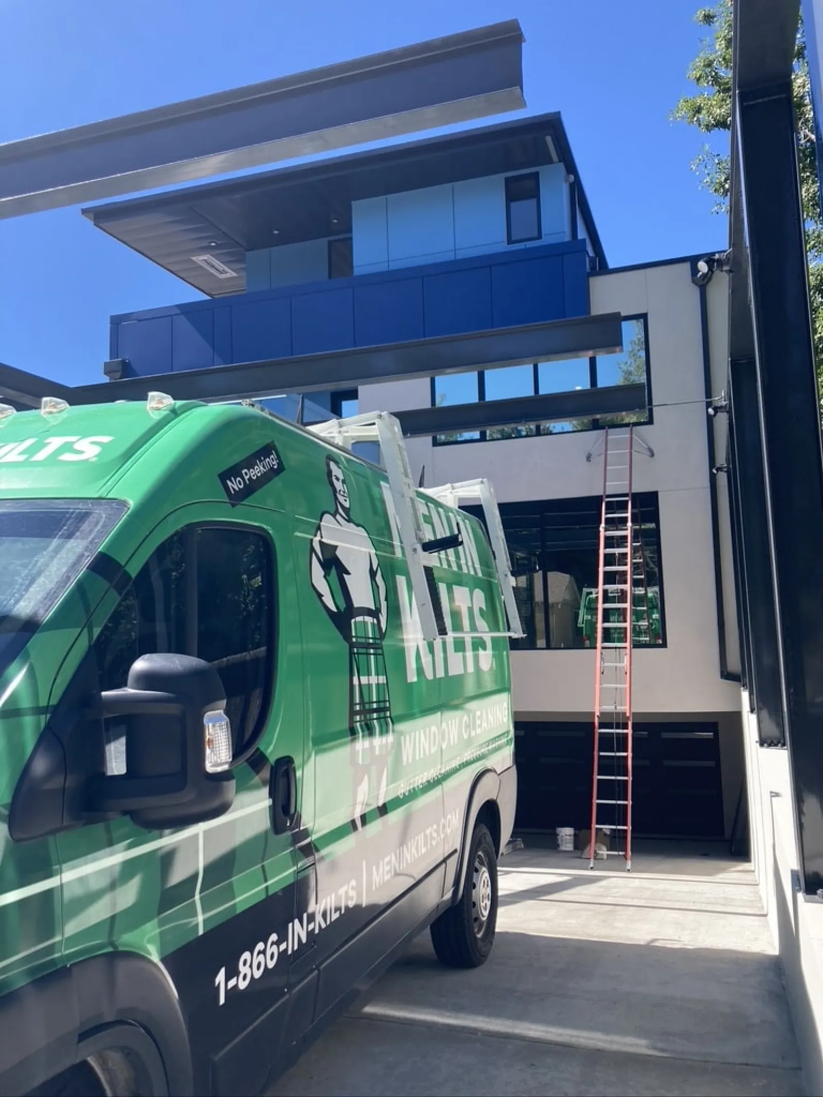 a green bus parked outside a building