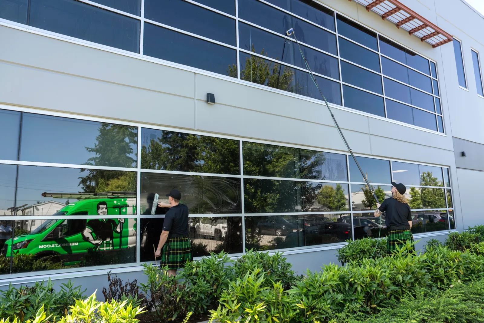 a couple of people standing outside a building with glass windows