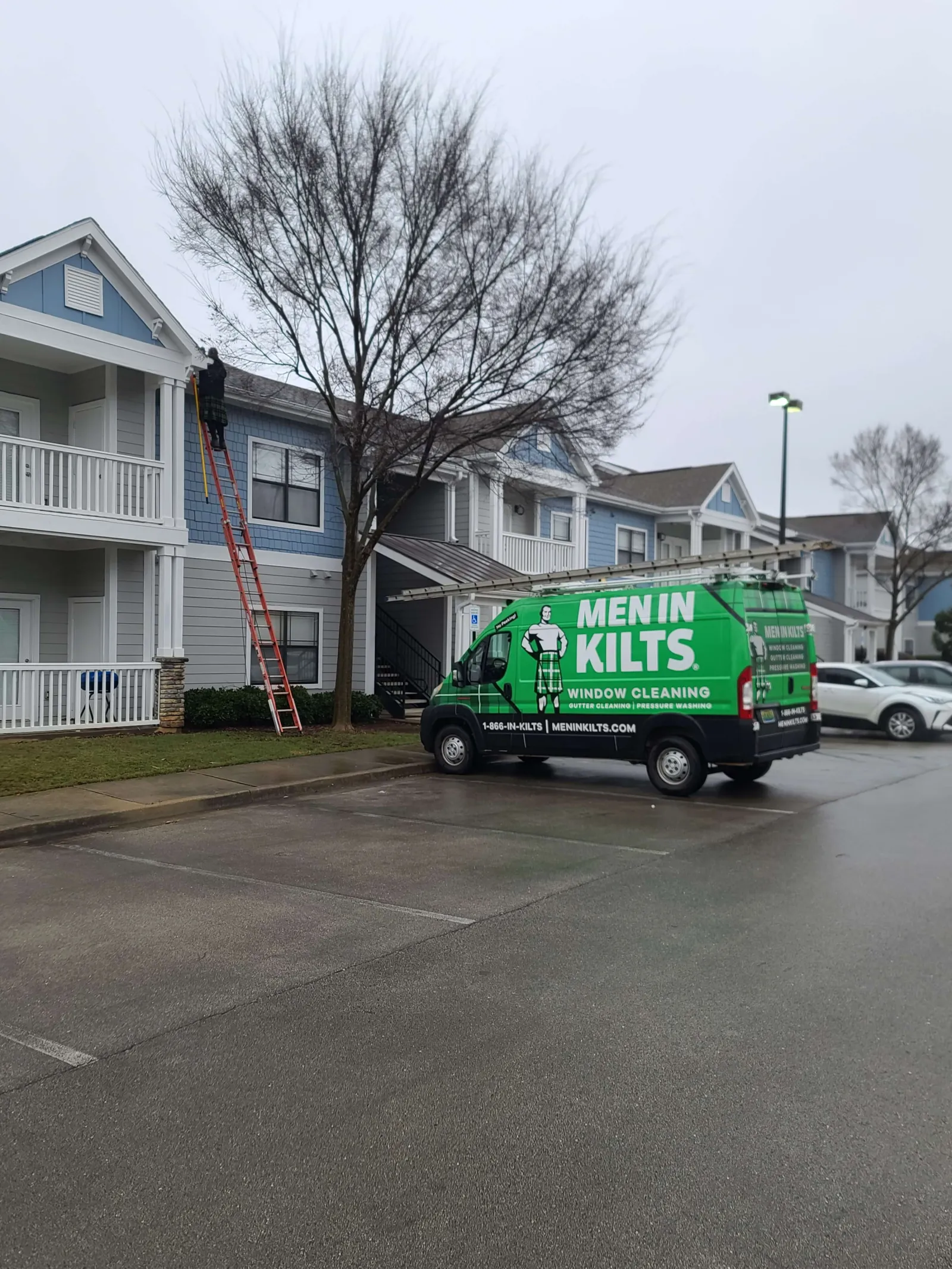 a green truck parked on the side of a street