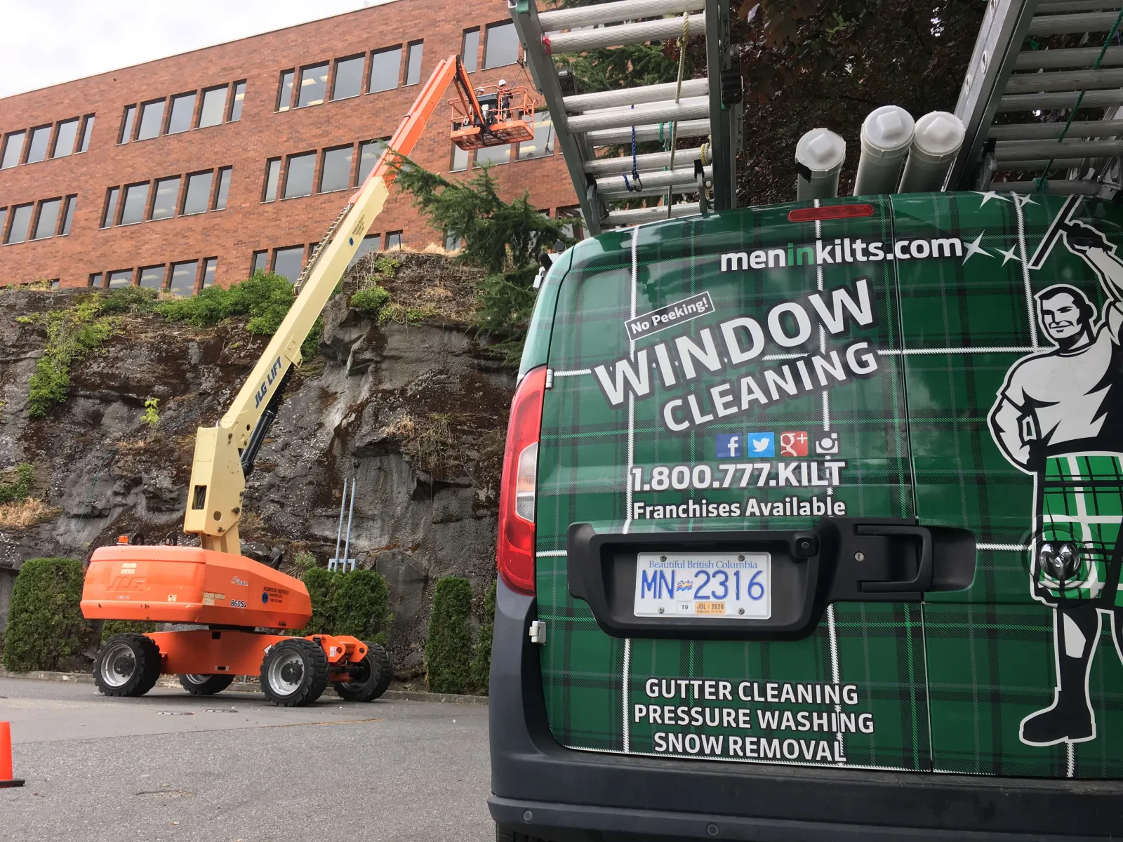 a green truck with a crane