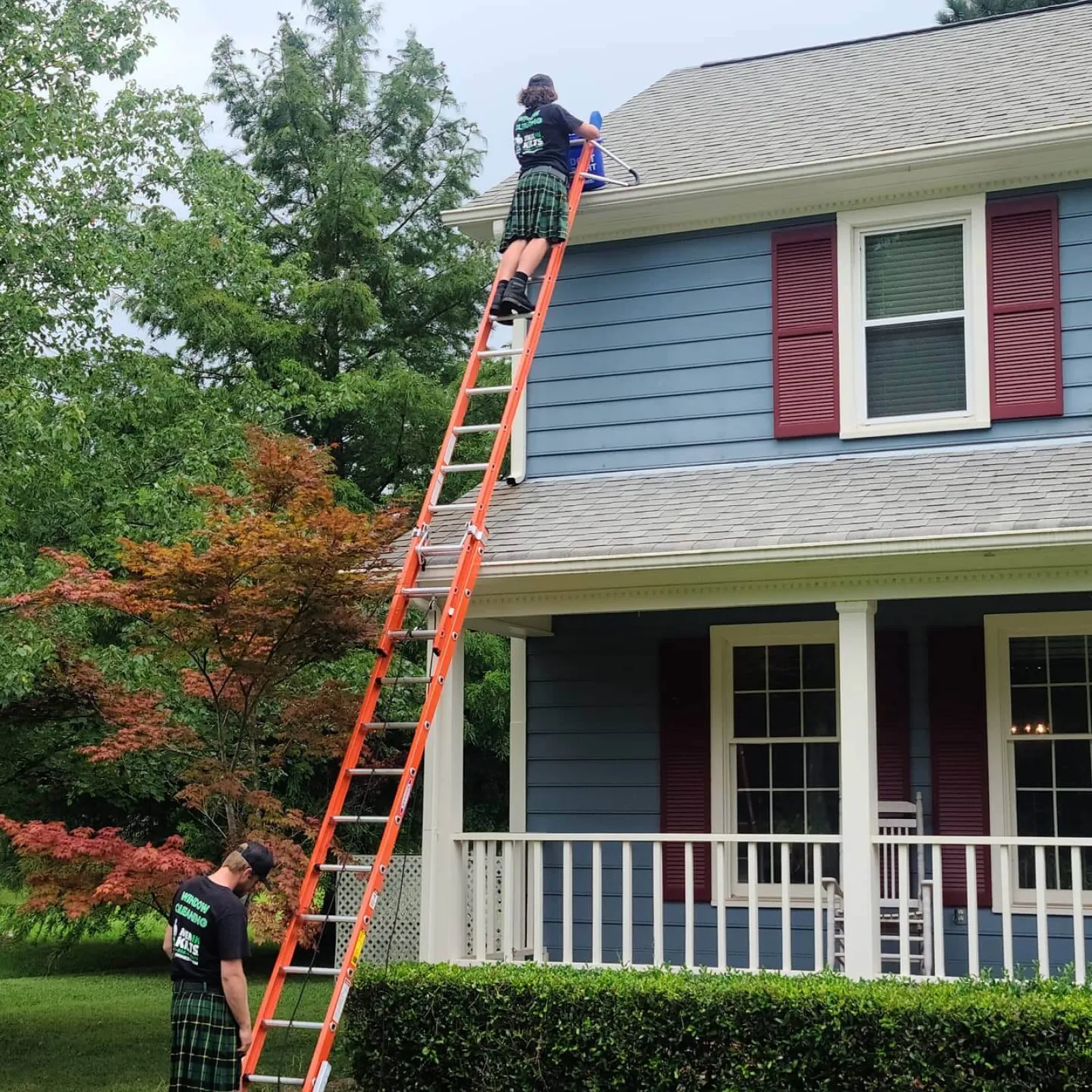 a person on a ladder on a house