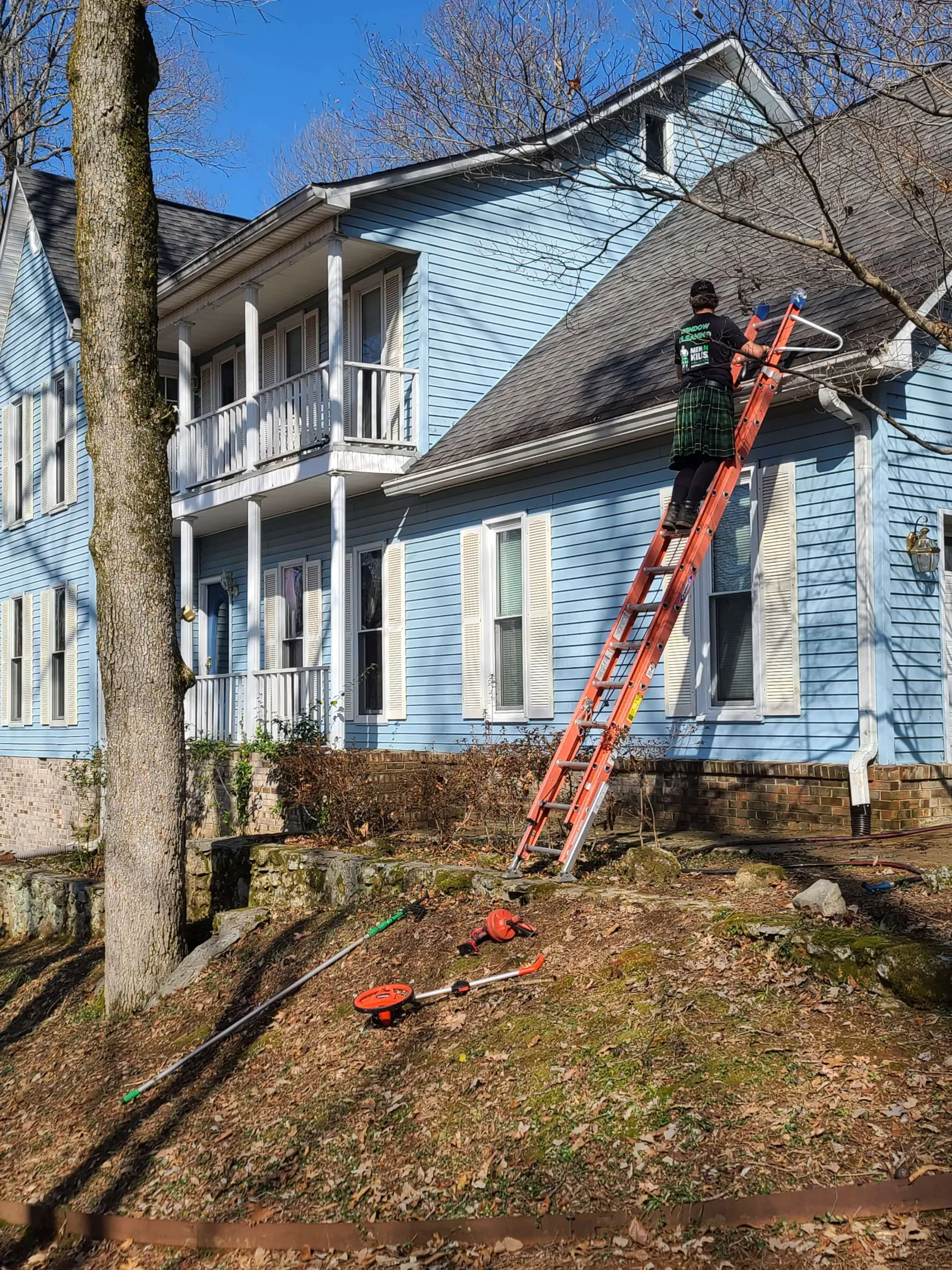 a person on a ladder on a house