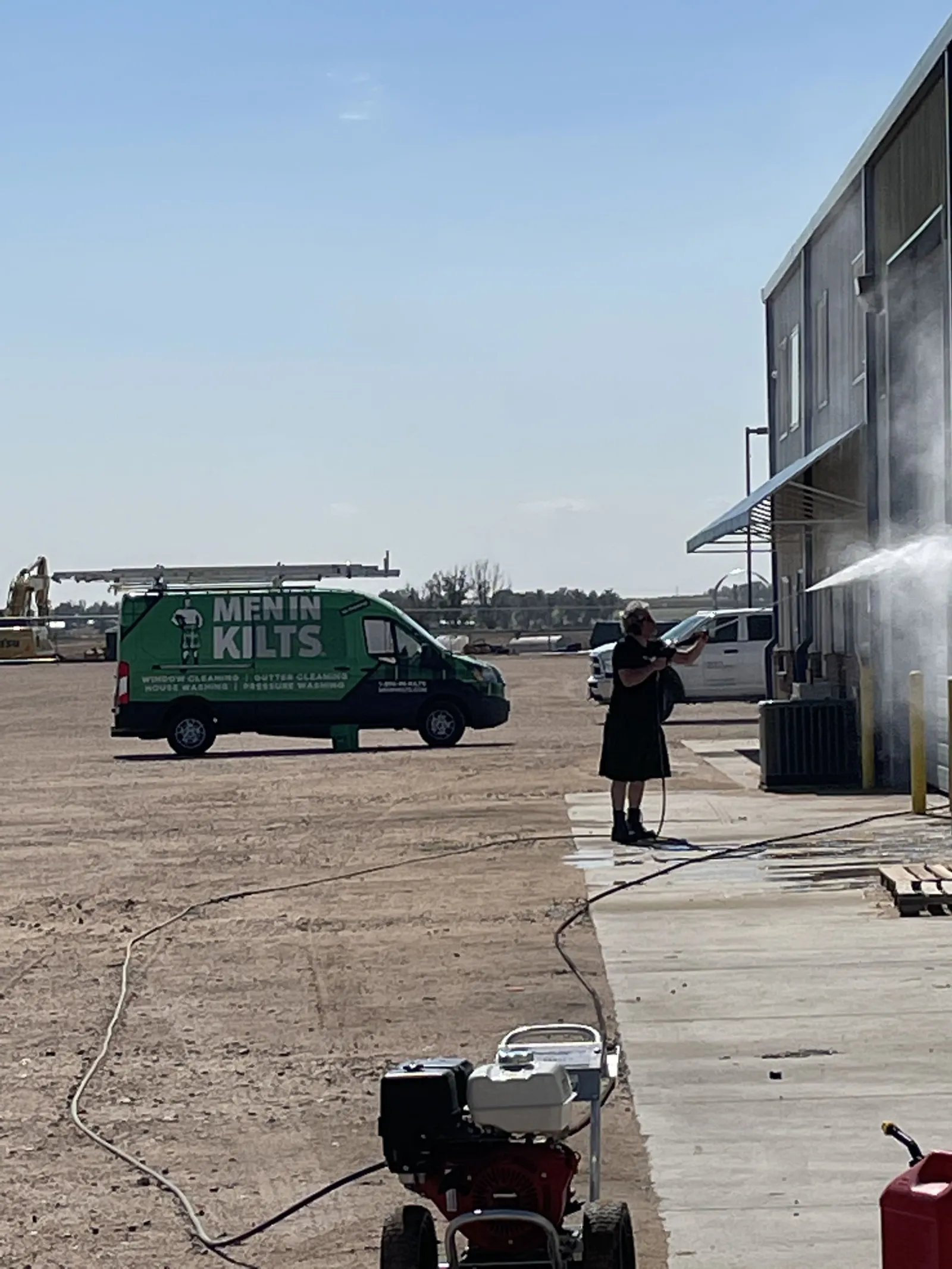 a person standing next to a green truck