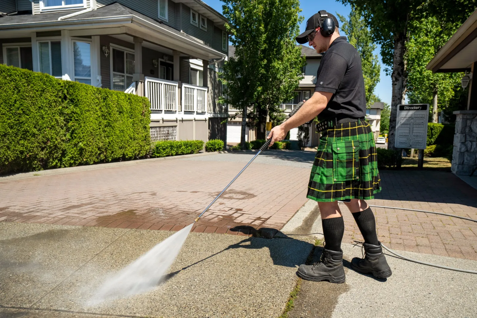 a man wearing a kilt and holding a stick