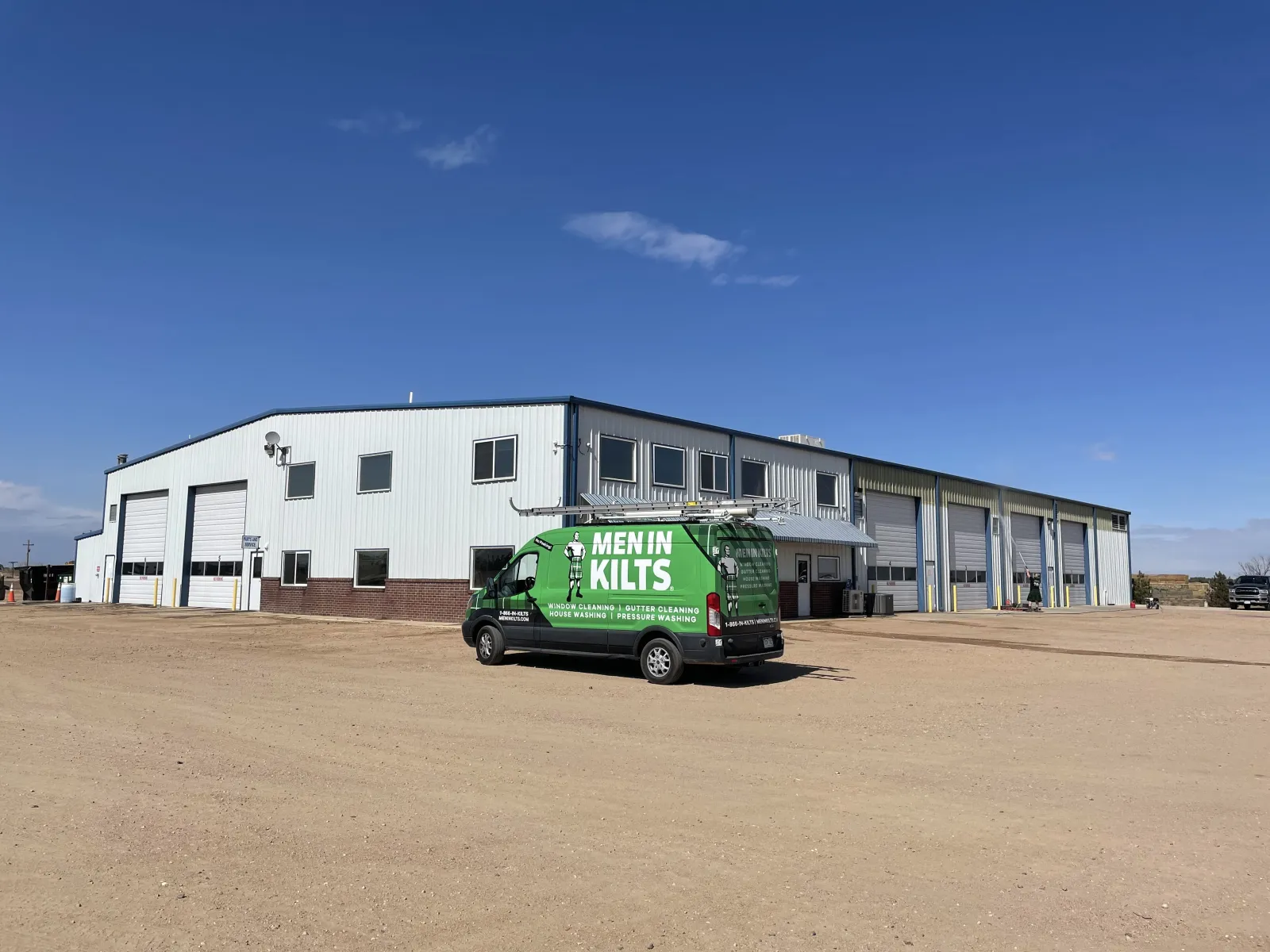 a green truck parked in front of a building