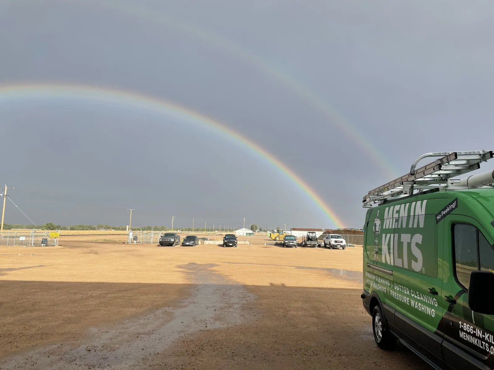 a rainbow over a parking lot