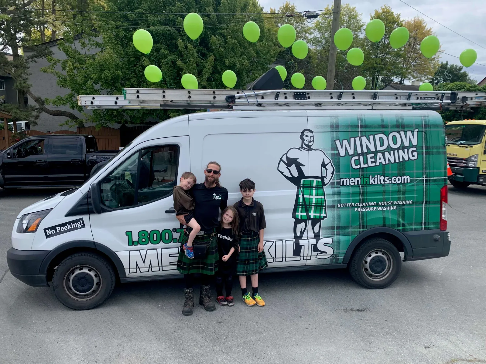 a group of people posing for a photo in front of a van