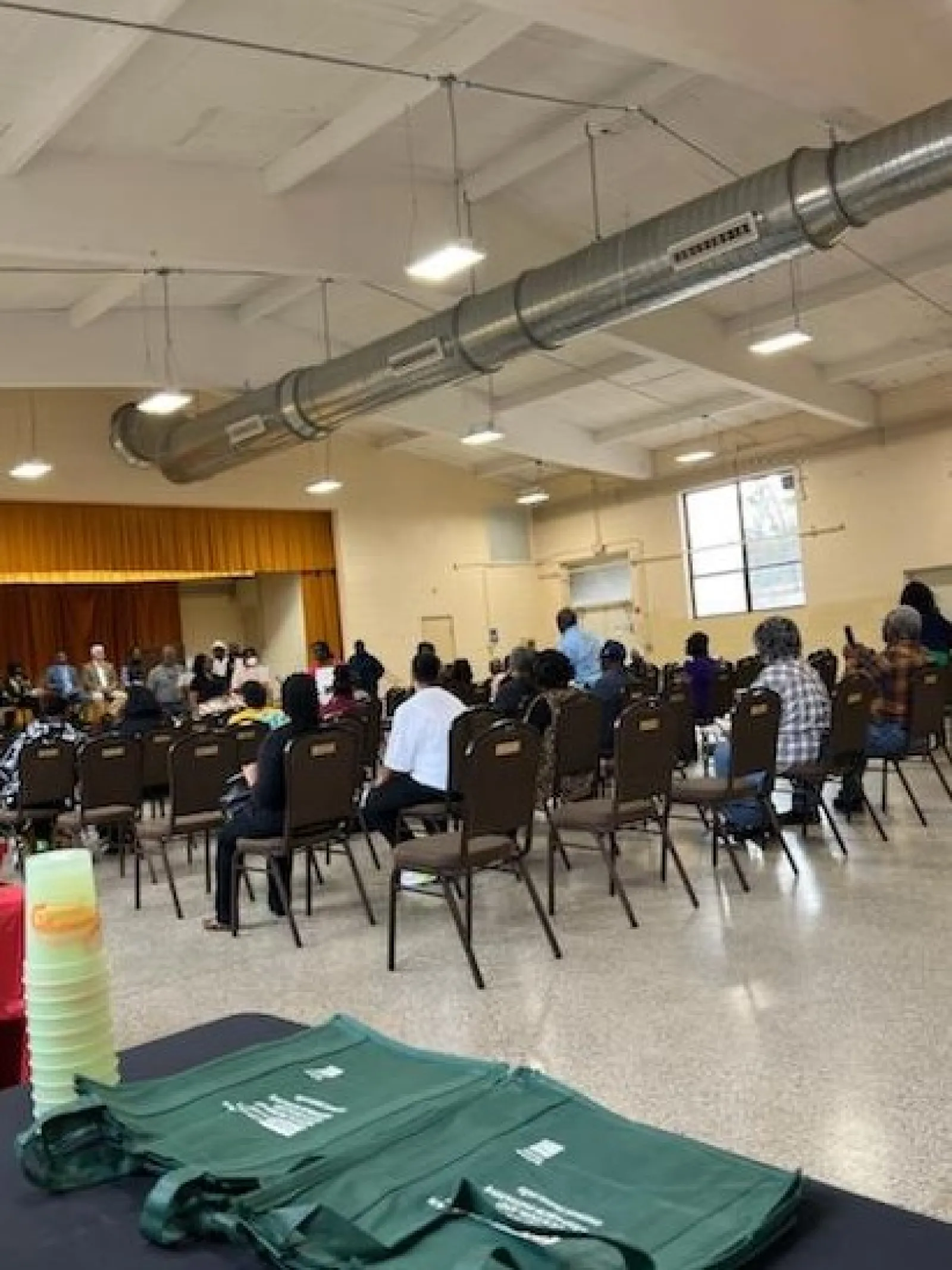 a group of people sitting in a room with a large screen