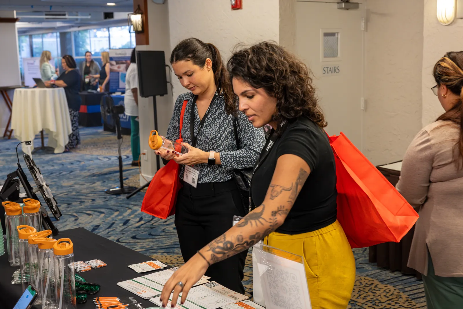 a couple of women looking at a piece of paper