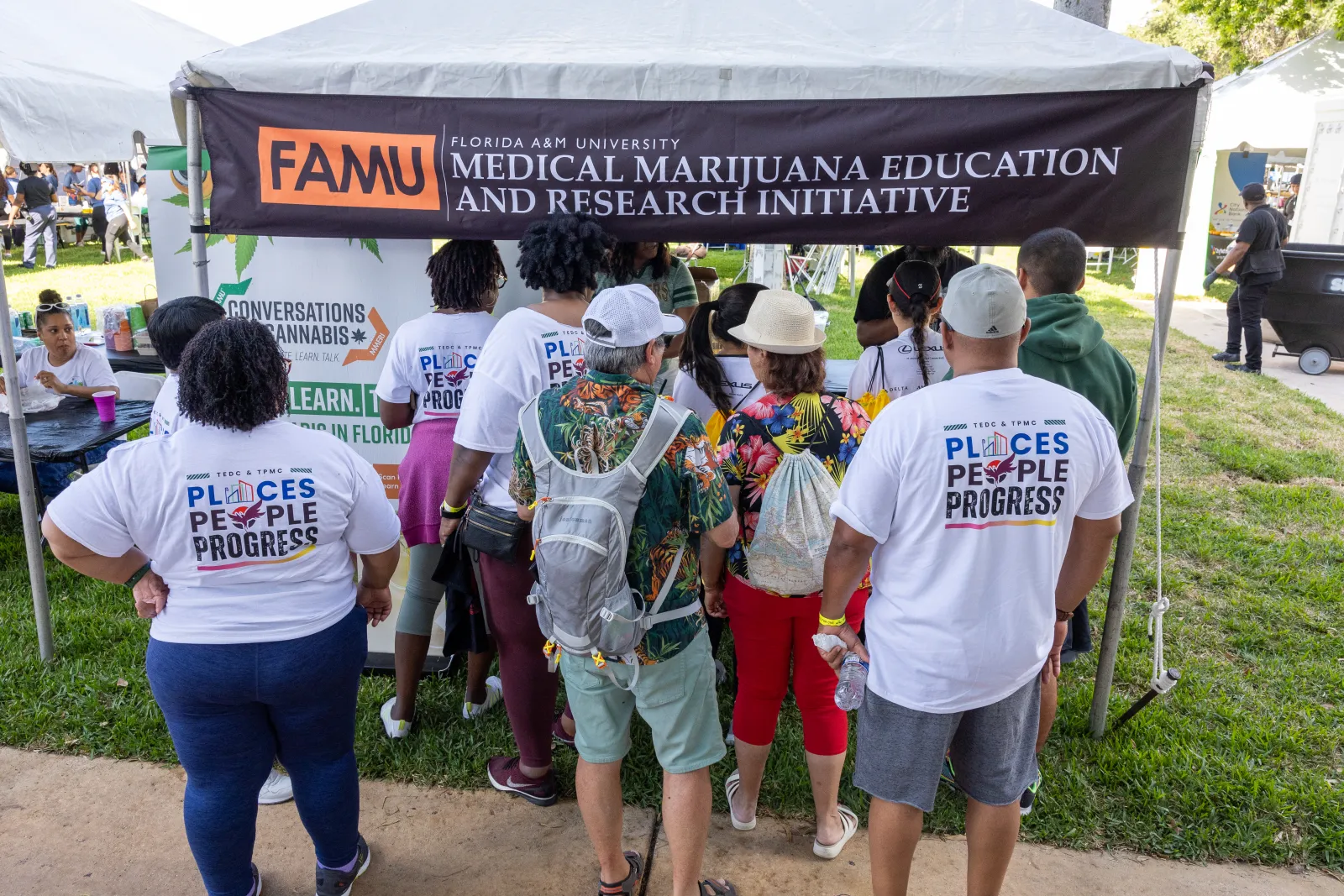 a group of people standing under a tent