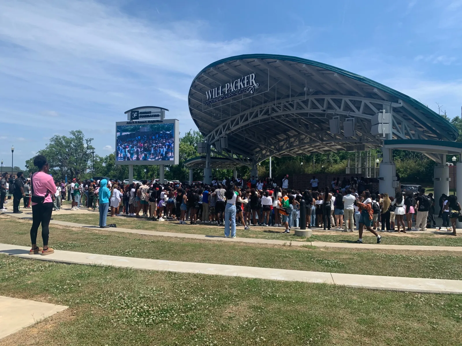 Crowd gathers at Will Packer outdoor stage under clear sky during daytime event
