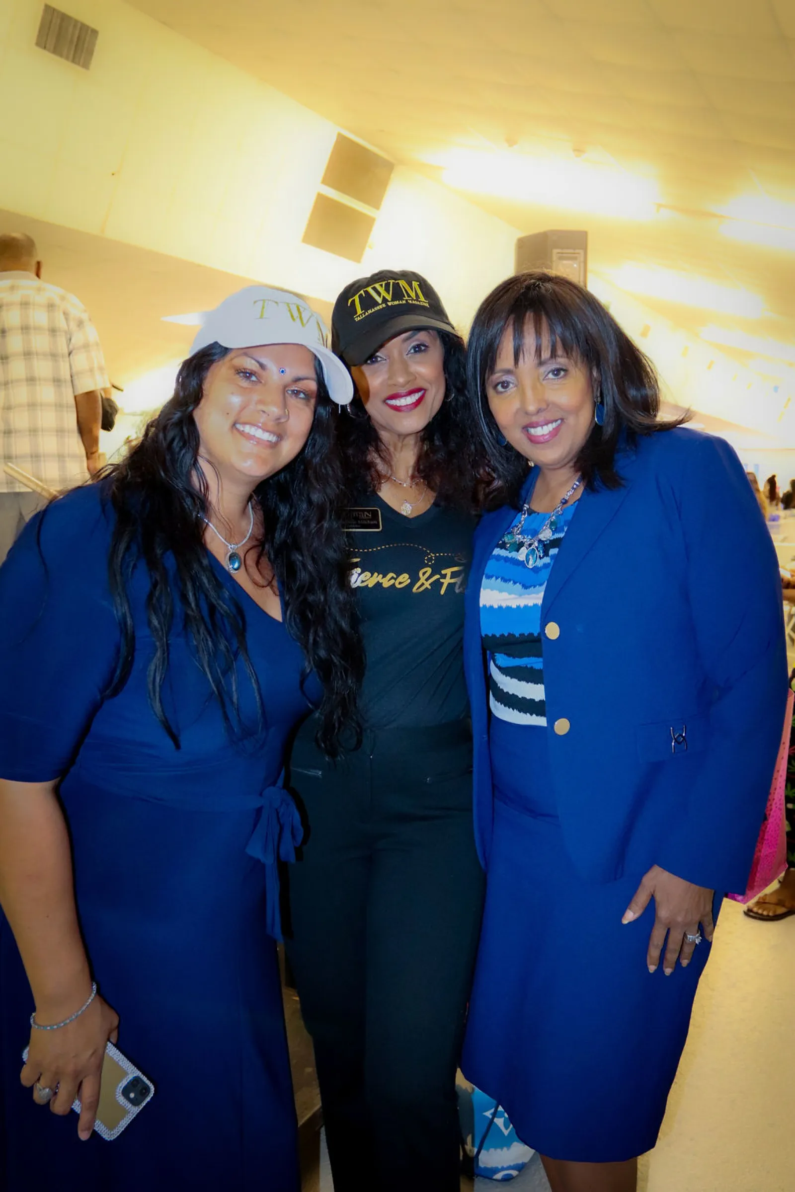 a group of women in blue dresses