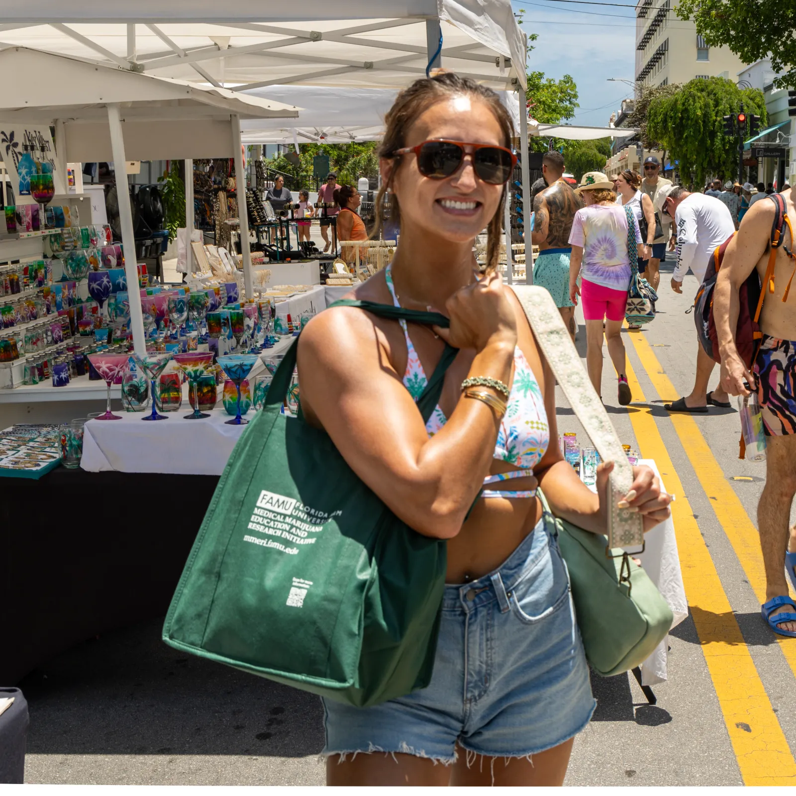 a woman holding a green bag