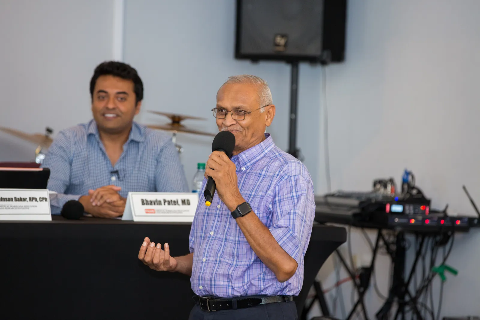 Dr Bhalani Bhalani speaking into a microphone