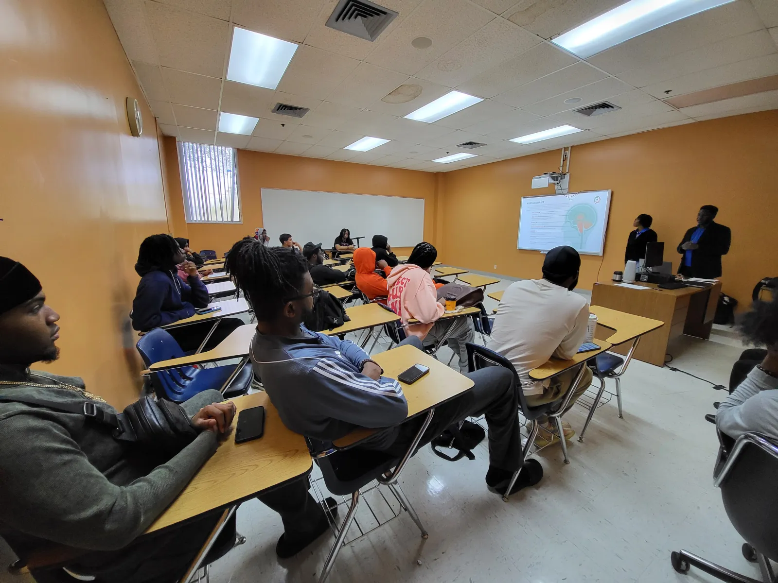 a group of people sitting in a classroom