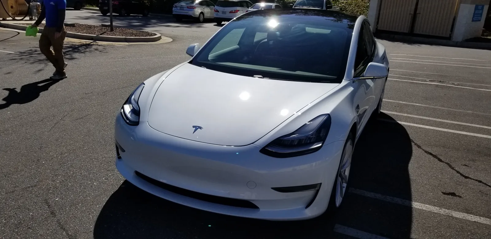 a white car parked in a parking lot