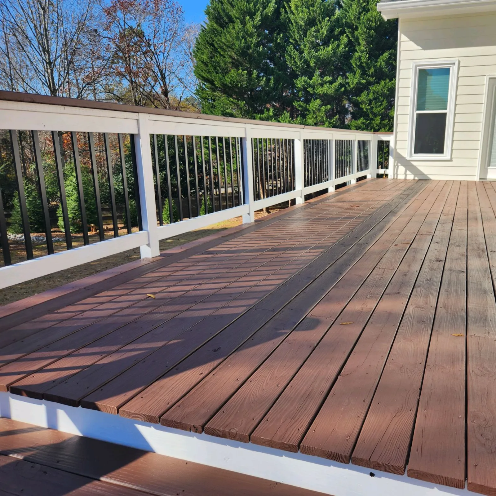 a deck with a wood railing