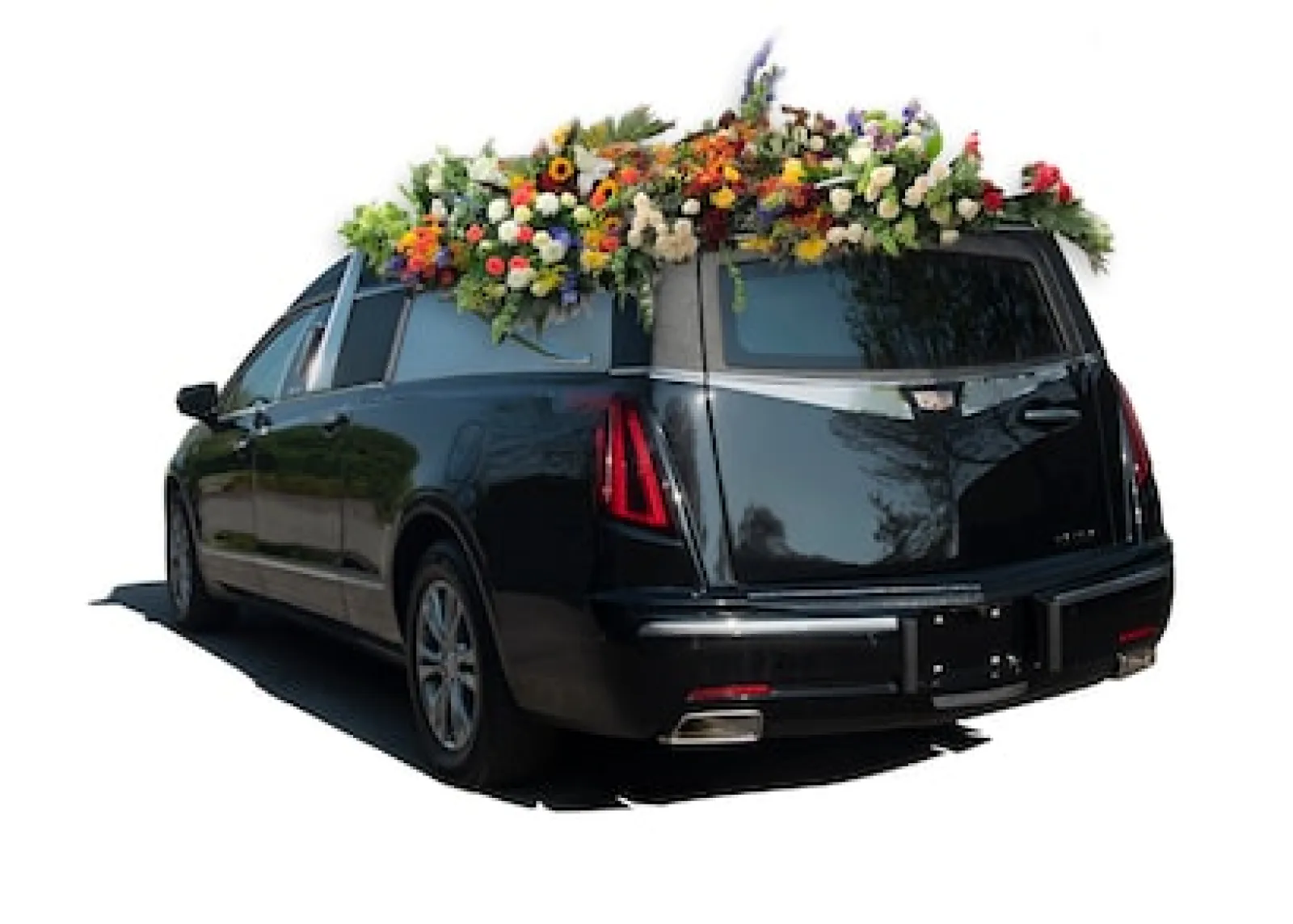 A hearse adorned with vibrant flowers, showcasing floral arrangements atop a sleek black vehicle.