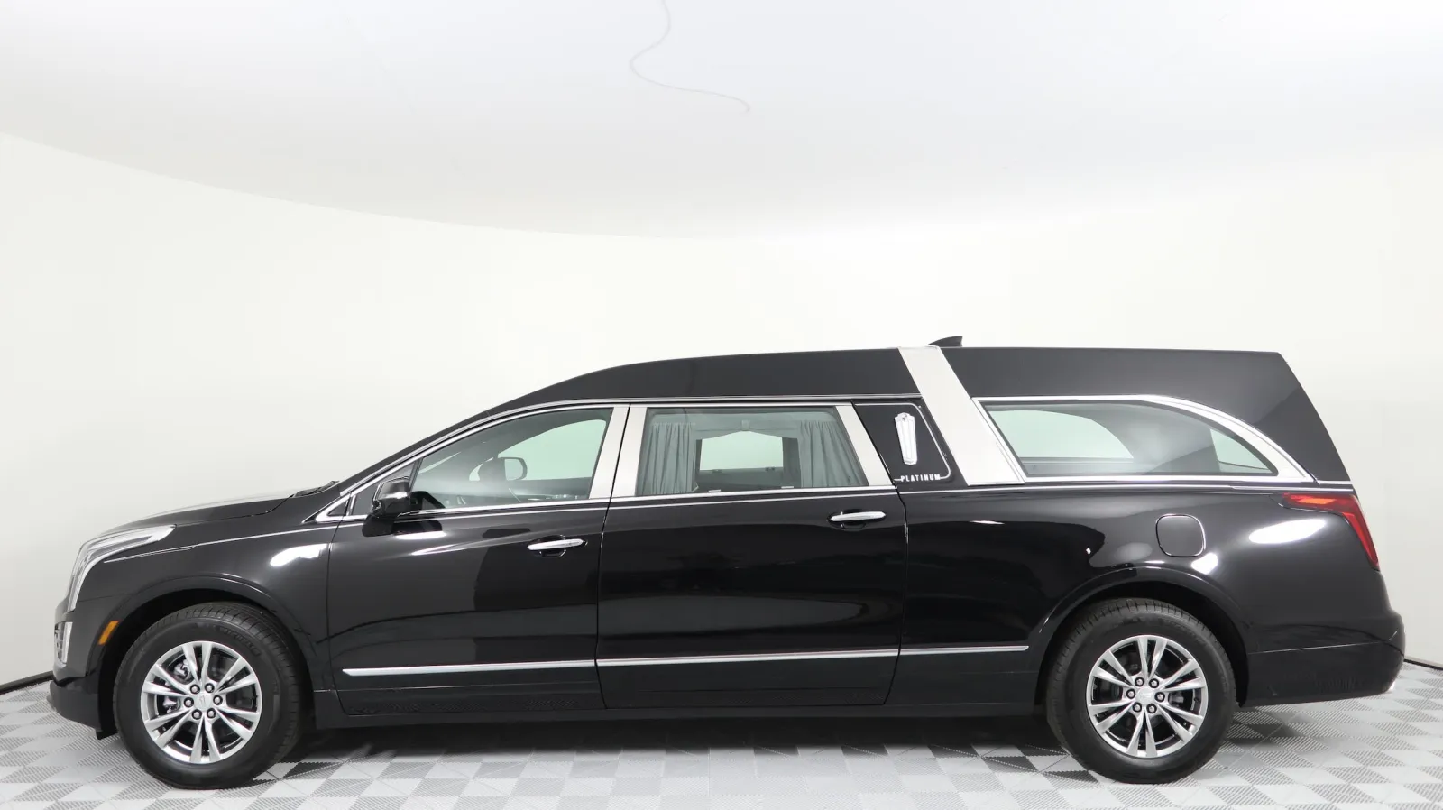 Elegant black hearse with silver accents, showcasing a luxury vehicle design.