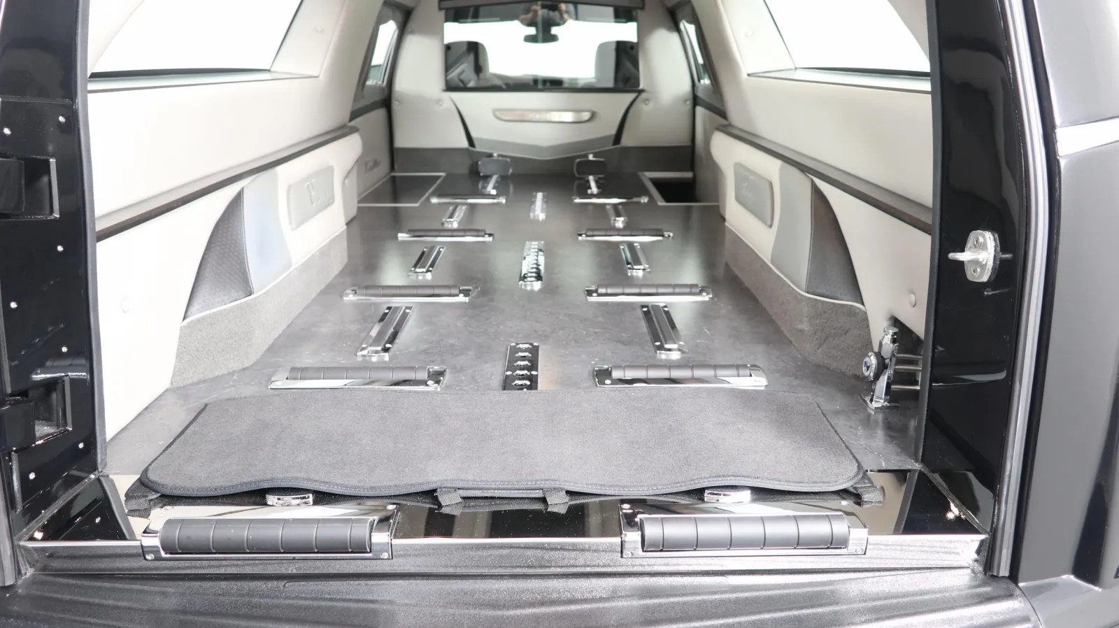 Interior view of a hearse with a spacious compartment designed for transporting caskets.