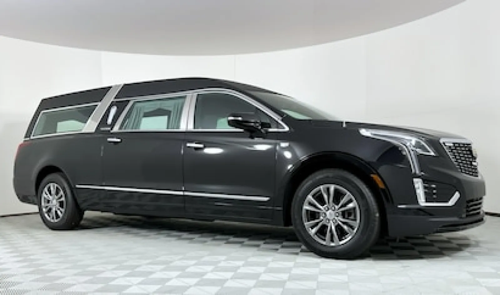 Black luxury Cadillac limousine featuring sleek lines and modern design.