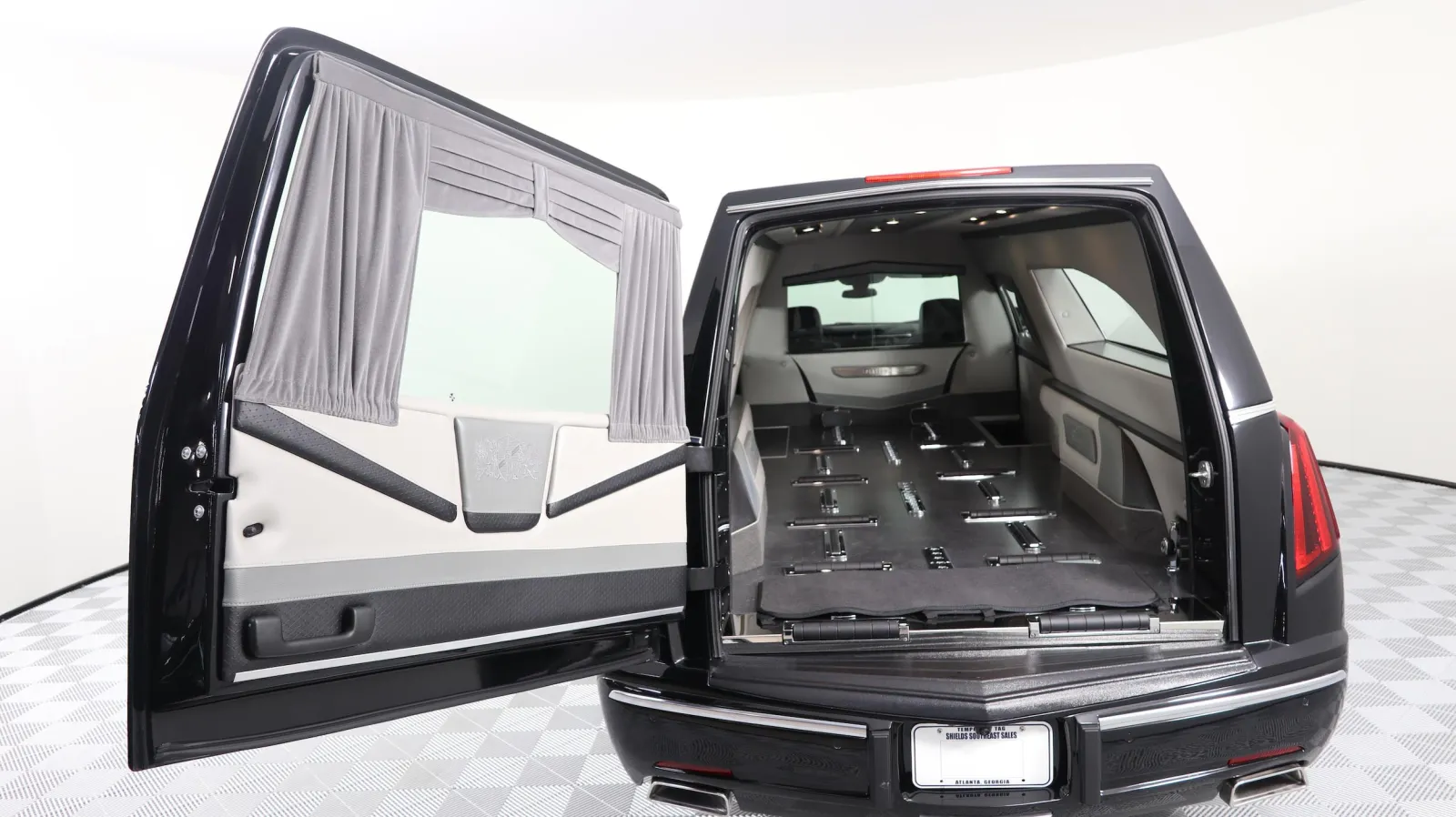 Interior view of a luxury black vehicle showcasing a spacious cargo area with sleek design.