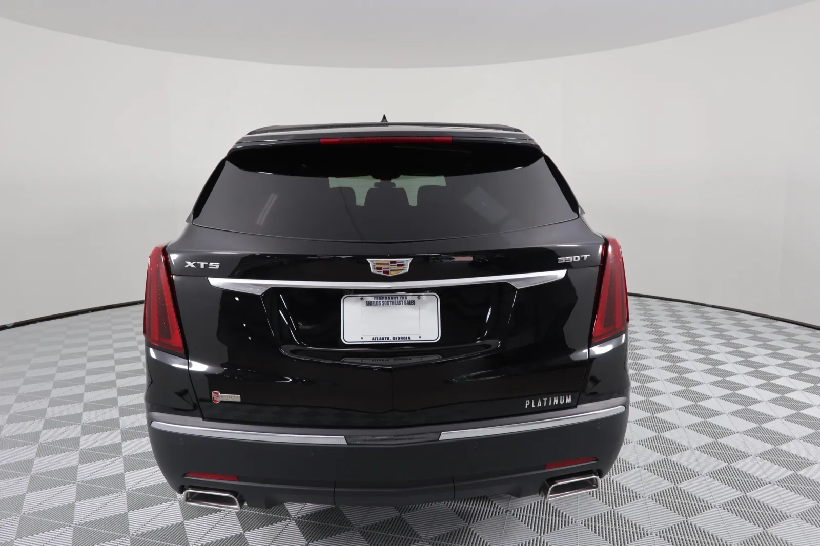 Rear view of a black Cadillac XT5 Platinum showcasing sleek design and modern features.