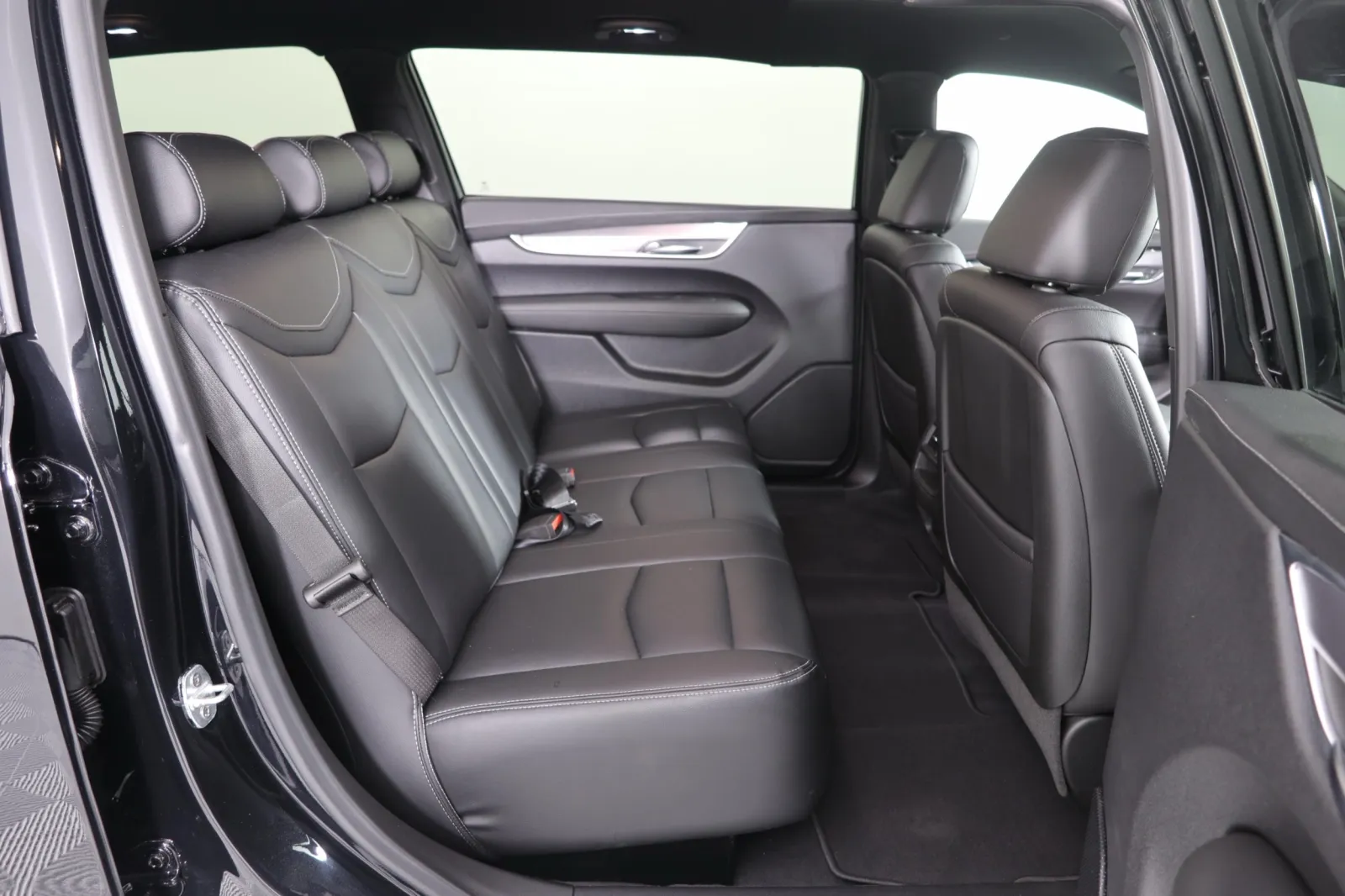 Interior view of a spacious SUV with black leather seating and a modern design.