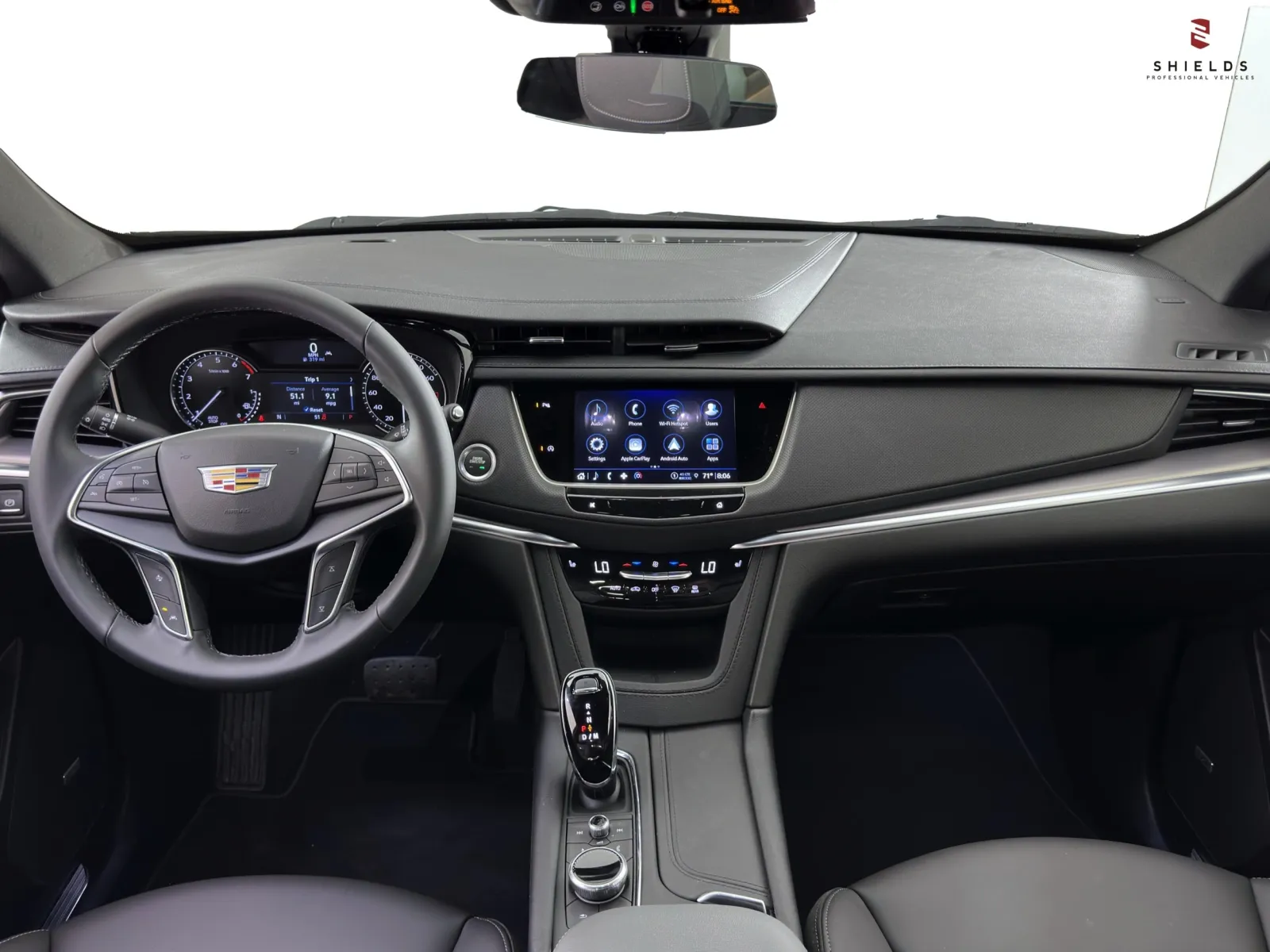 Interior view of a modern Cadillac dashboard featuring advanced tech and sleek design elements.
