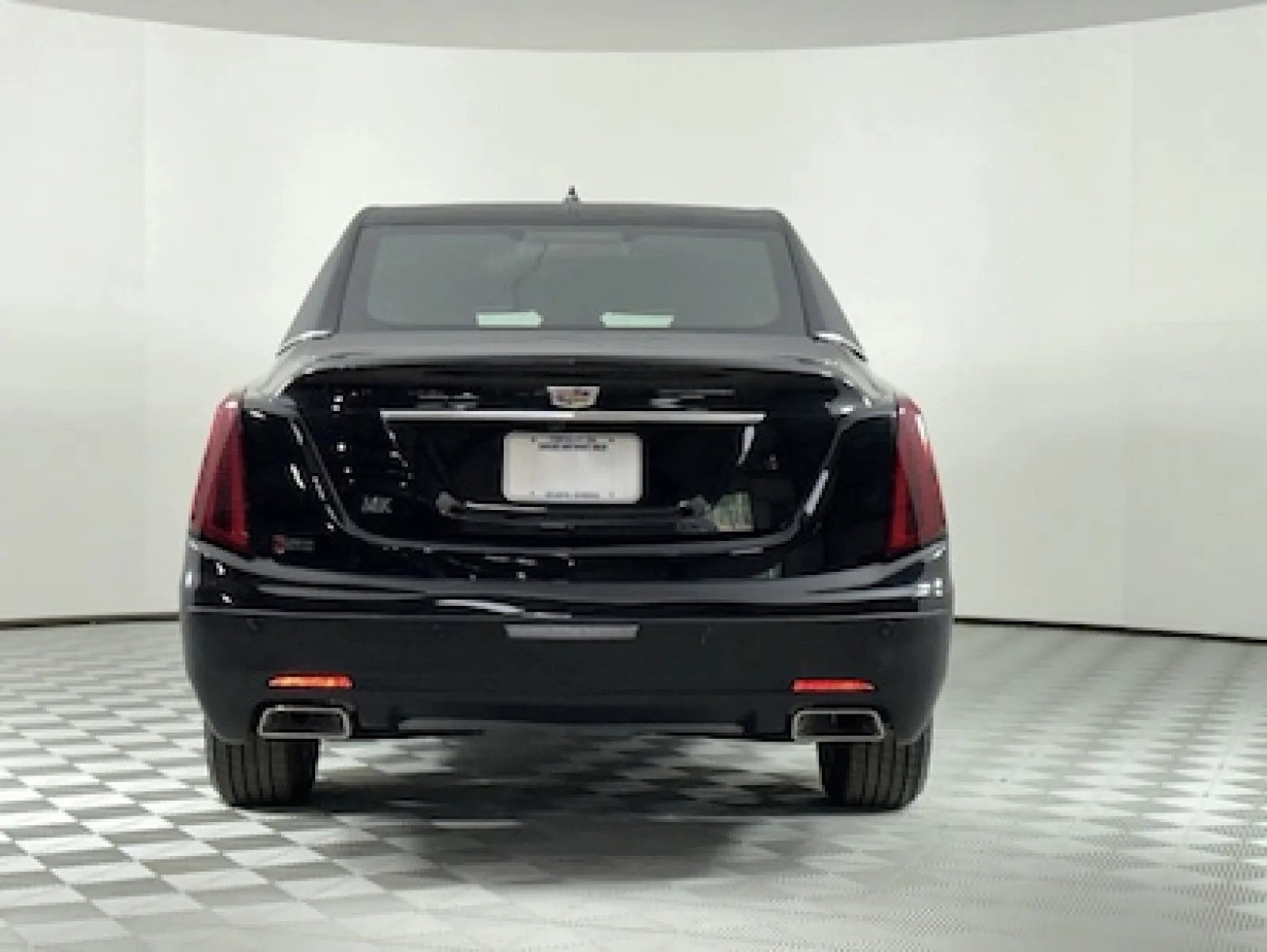 Rear view of a black Cadillac sedan with sleek design and modern taillights.