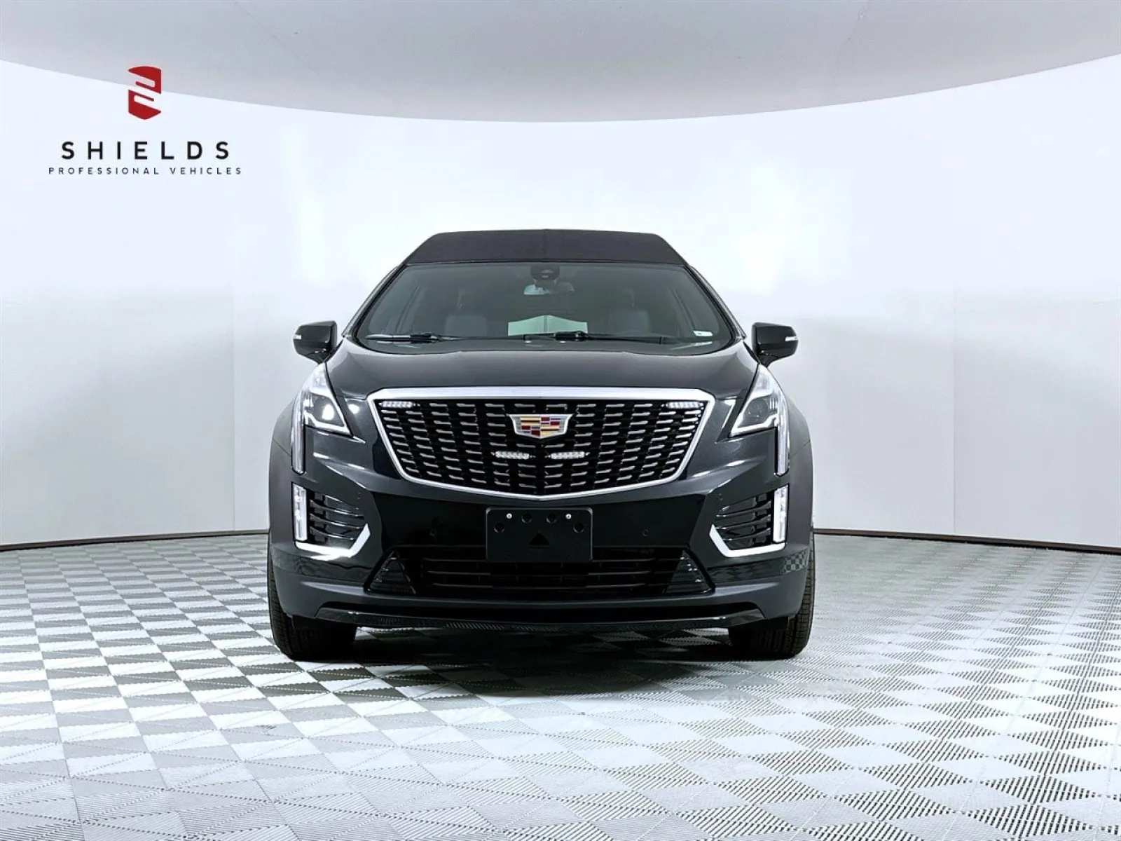 Front view of a black Cadillac XT5 showcasing its sleek design and distinctive grille.