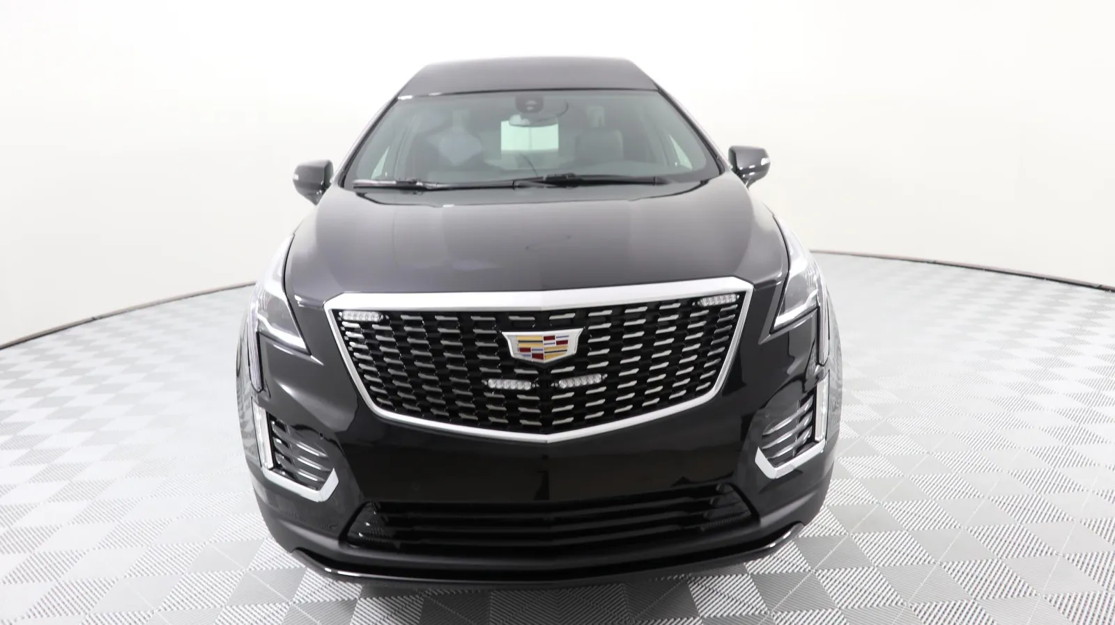 Front view of a sleek black Cadillac XT5 showcasing modern design and luxury features.