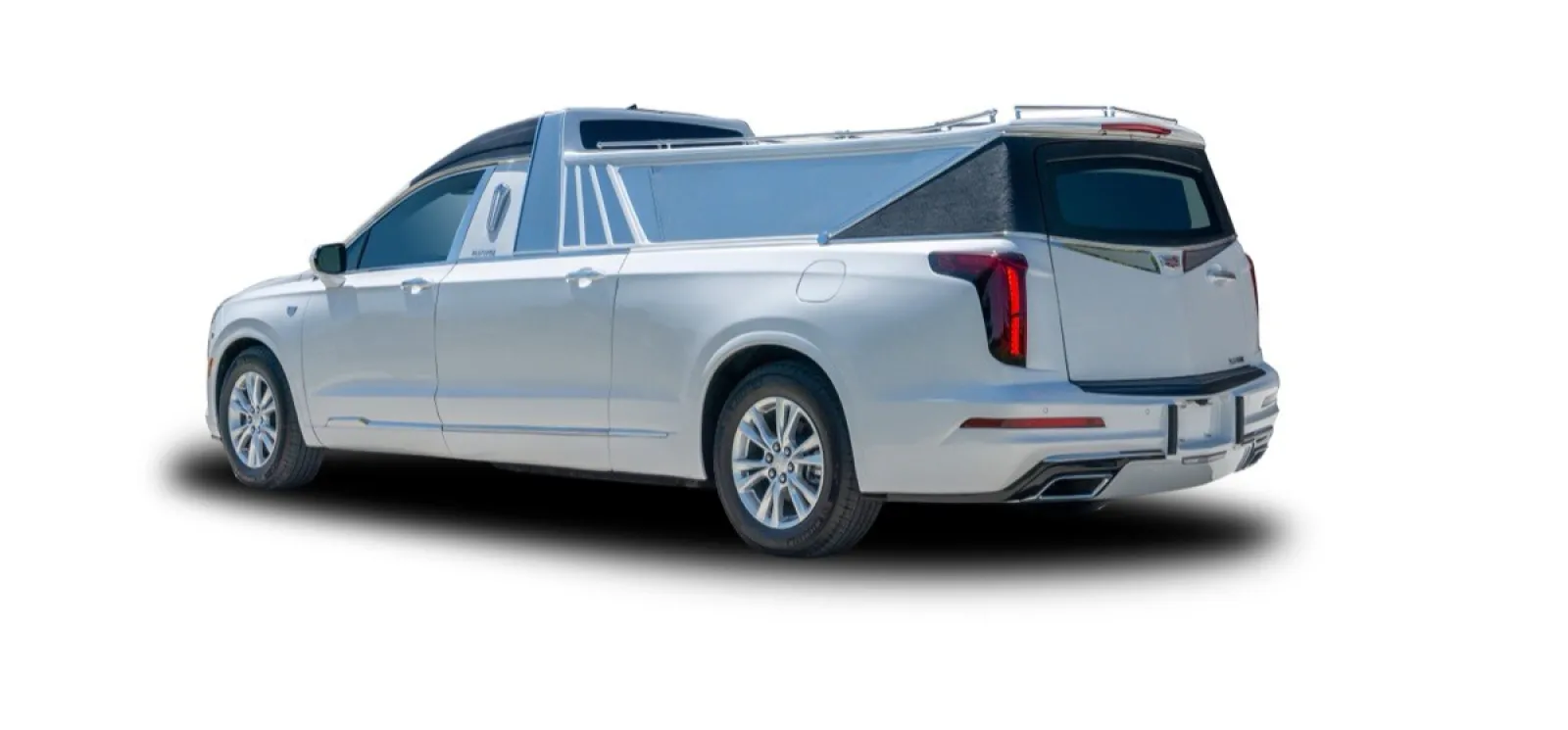 Rear view of a sleek silver pickup truck with a custom bed cover and stylish wheels.