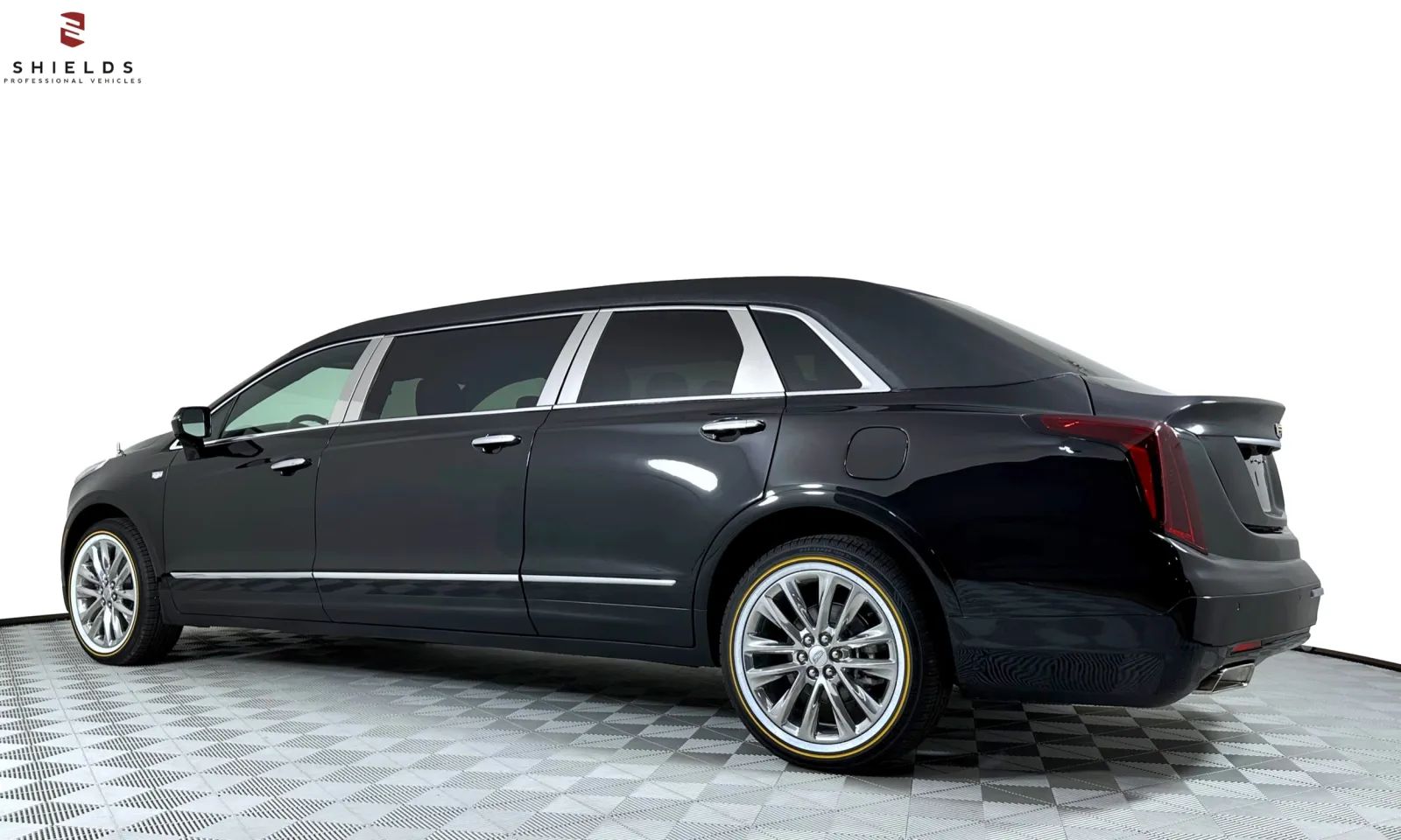 Sleek black luxury limousine showcasing polished wheels and elegant design.