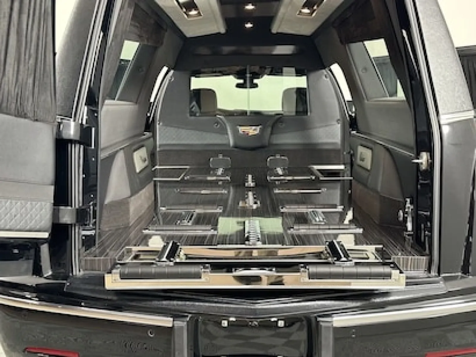 Interior view of a spacious SUV trunk with foldable seats and modern features.