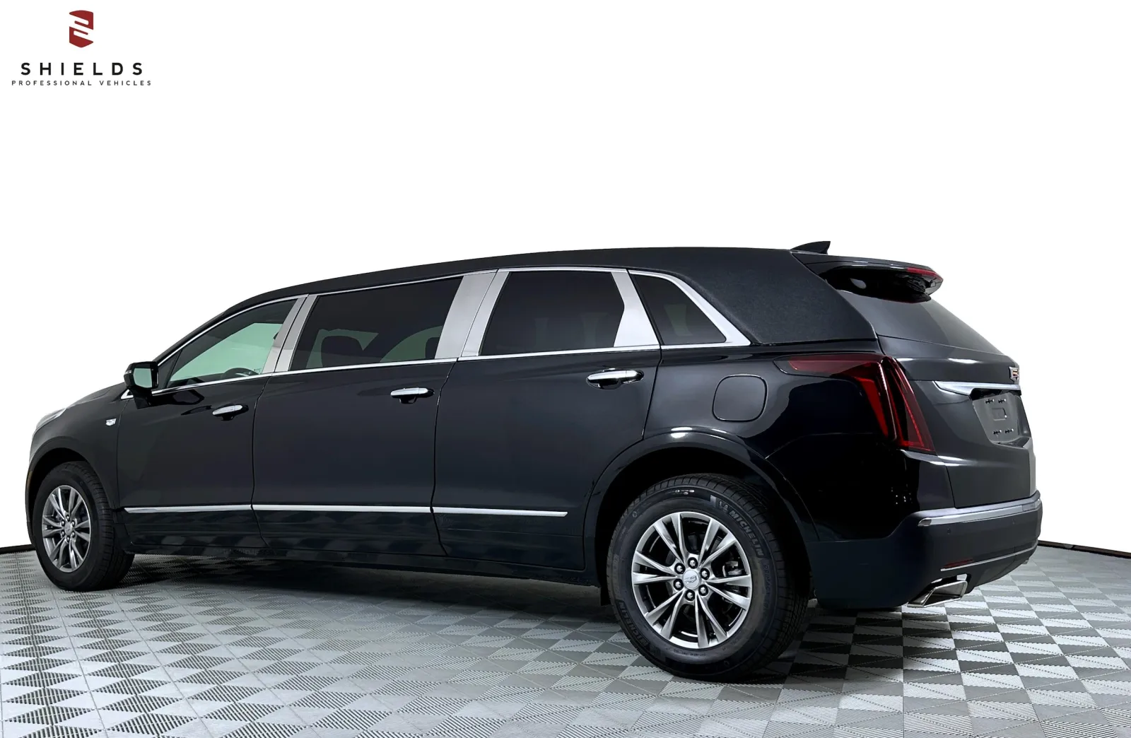 Luxurious black Cadillac limousine with polished details, showcasing its elegant design side view.