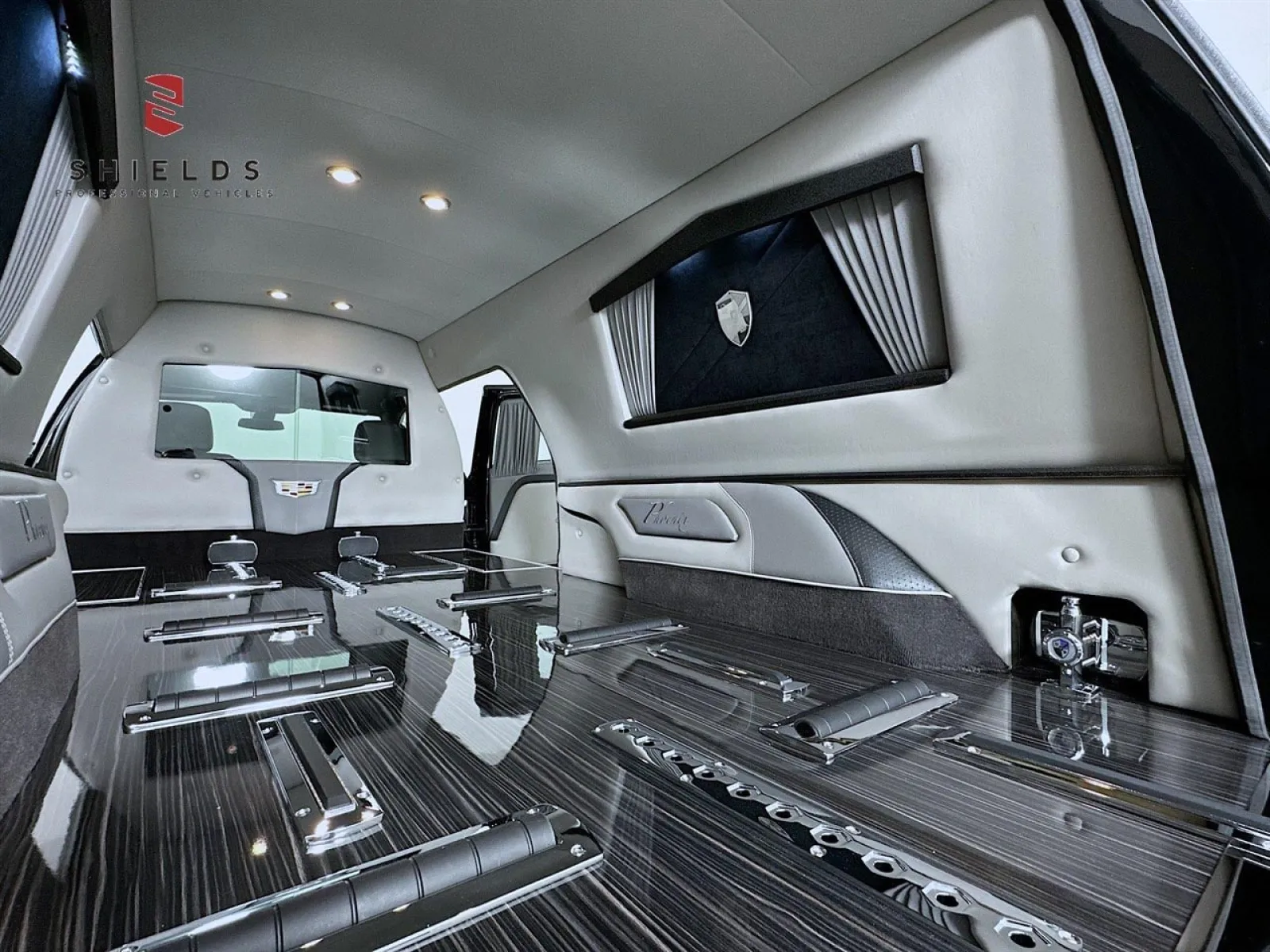 Luxurious interior of a high-end vehicle with sleek black surfaces and elegant lighting details.