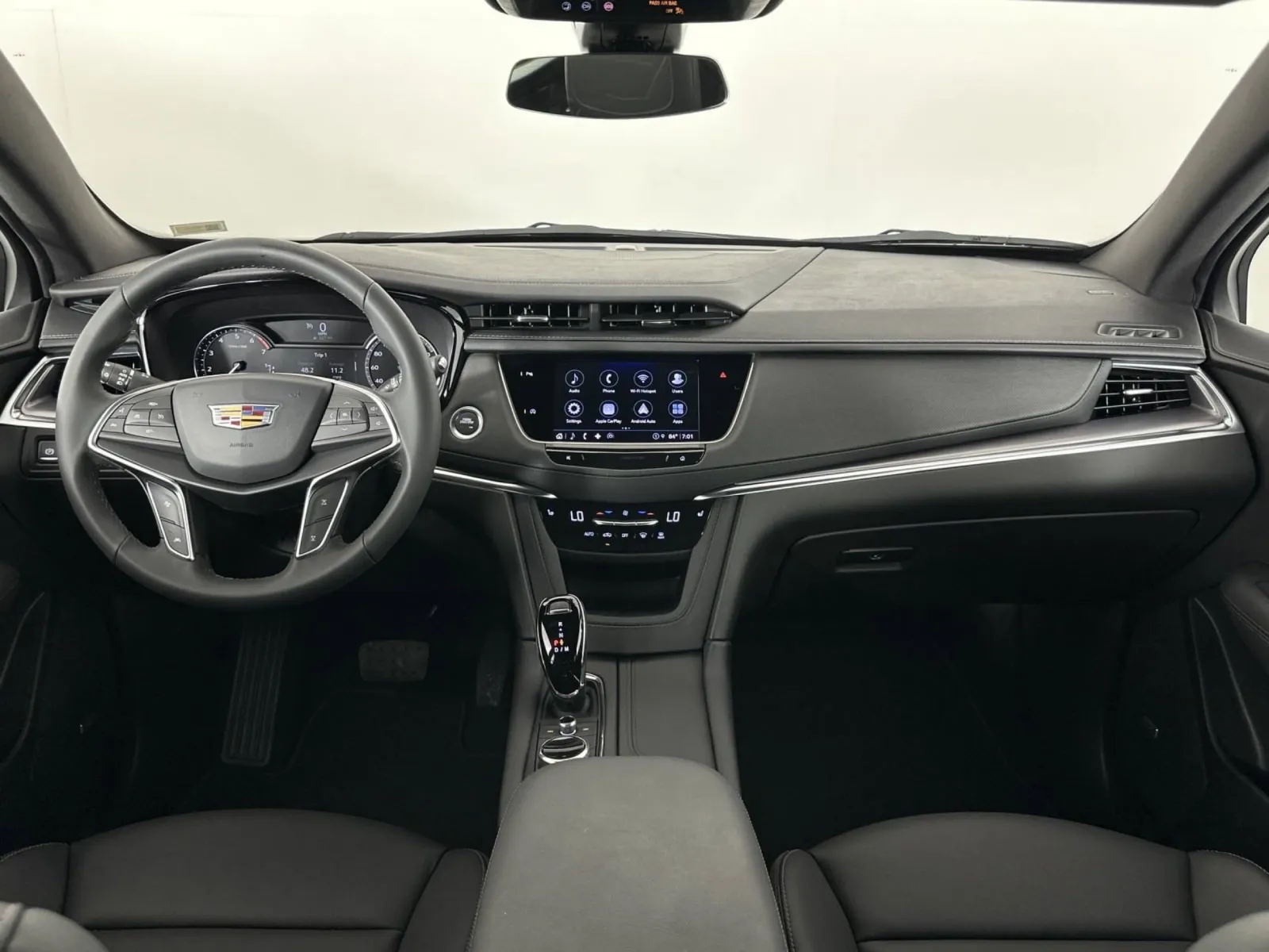 Modern Cadillac car interior featuring sleek dashboard and advanced technology display.