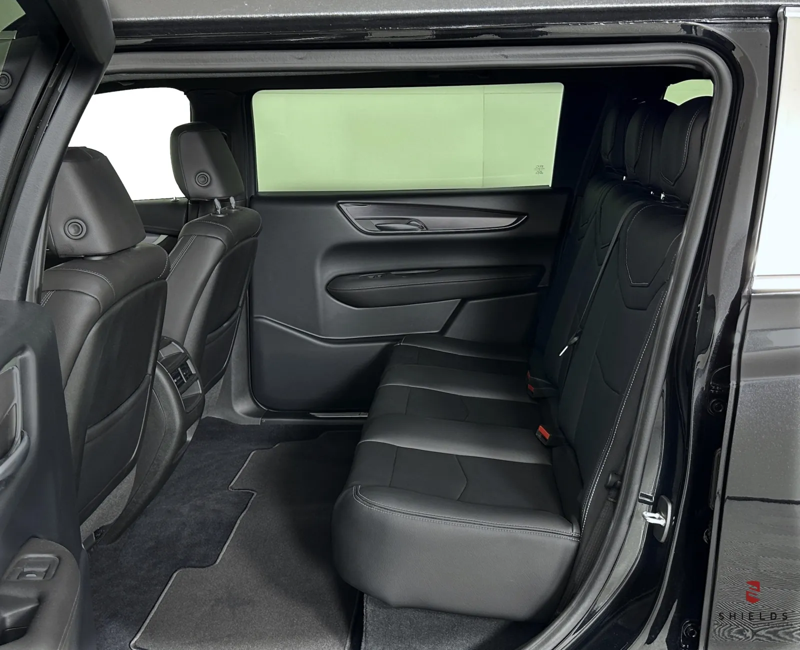 Interior view of a luxury SUV showcasing spacious black leather back seats.